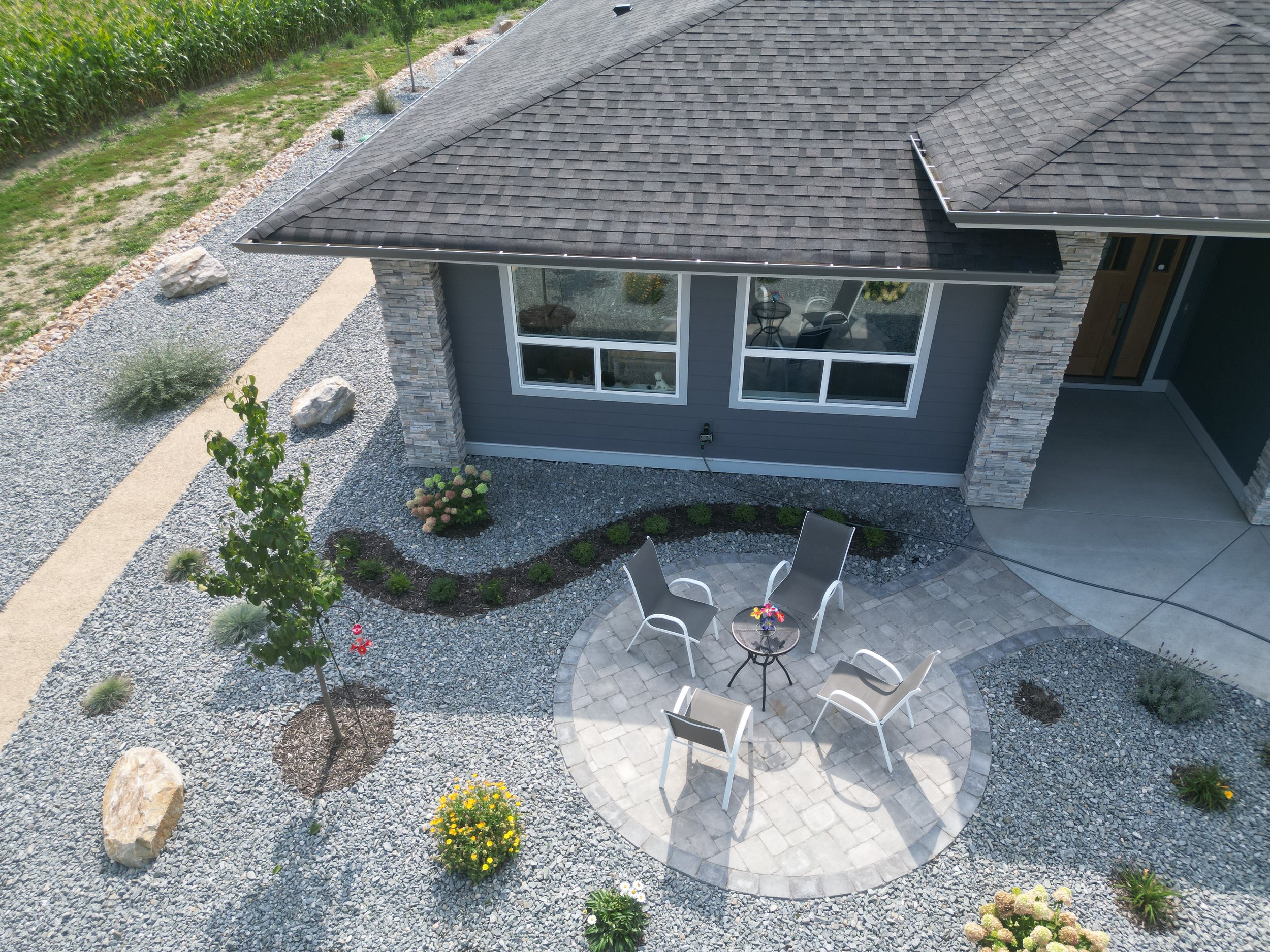 Circular patio built with Barkman Roman pavers in Blind Bay, BC featuring decorative rock landscaping and premium hardscape construction.