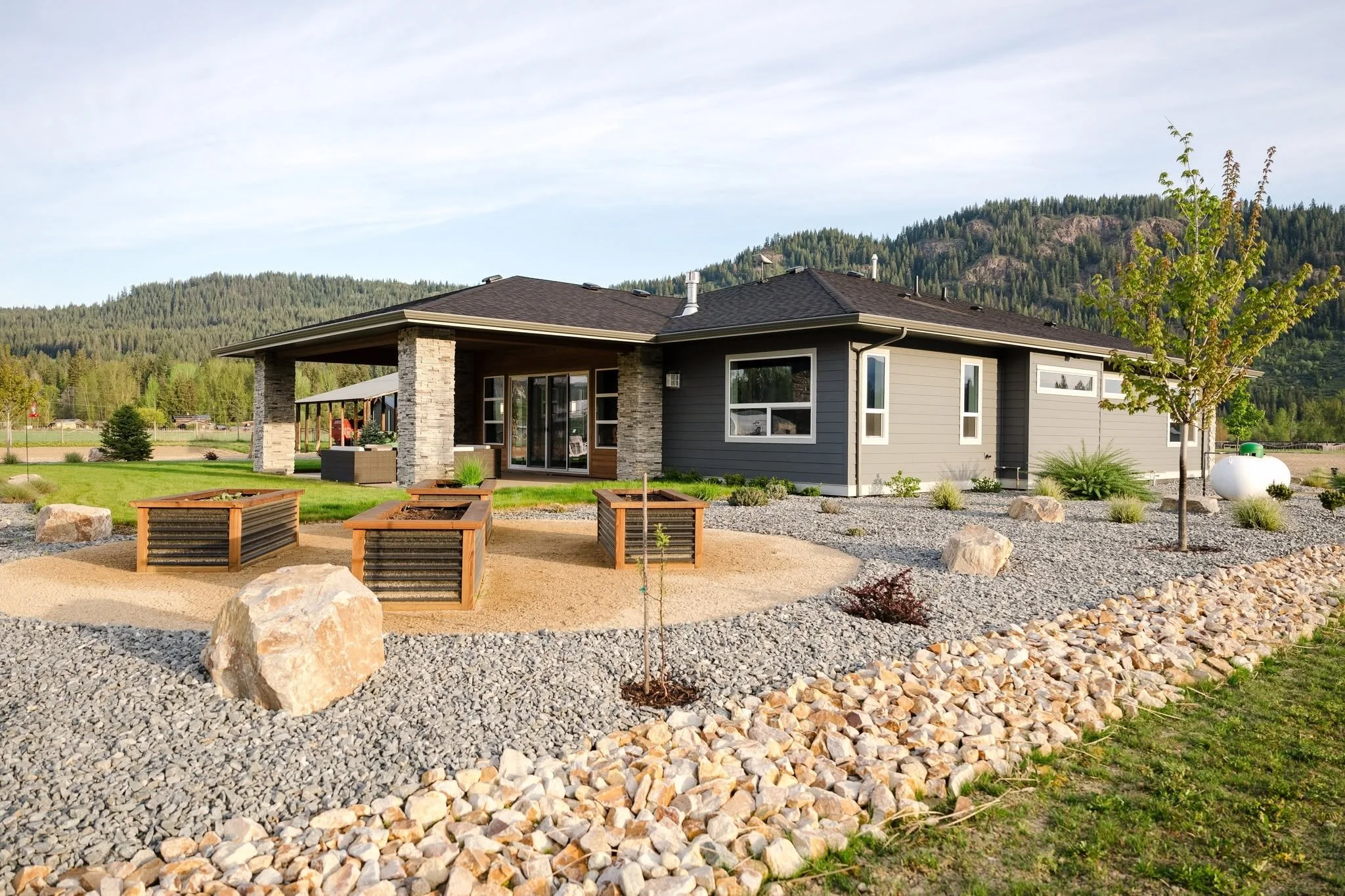 Complete landscape construction project including planting, decorative rock, grading, and irrigation installation. Salmon Arm, BC