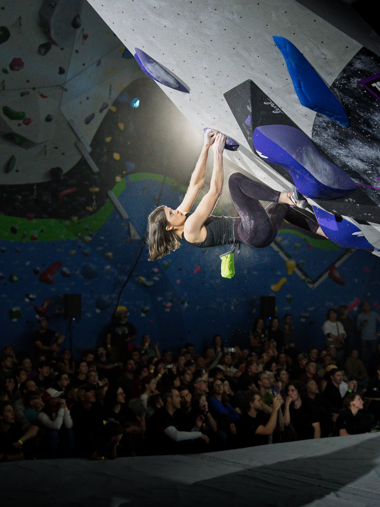 This is one of my favorite photos I took during finals so far. Climber @paloma.slowik rounding the corner on women's final 3. The back lighting illuminating her as she climbs was magical. The crowd in awe in the background is a nice finishing touch.