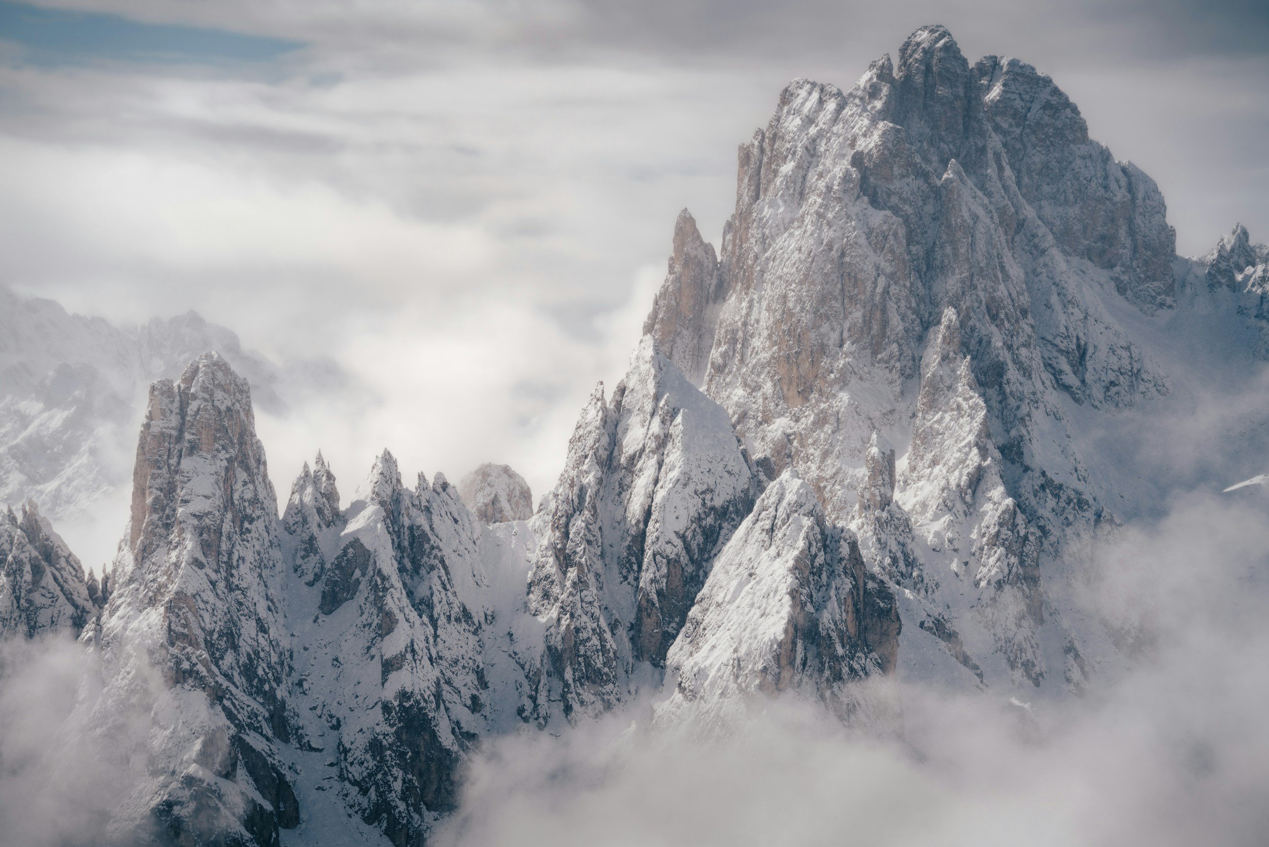 Snow-capped mountain peaks shrouded in clouds