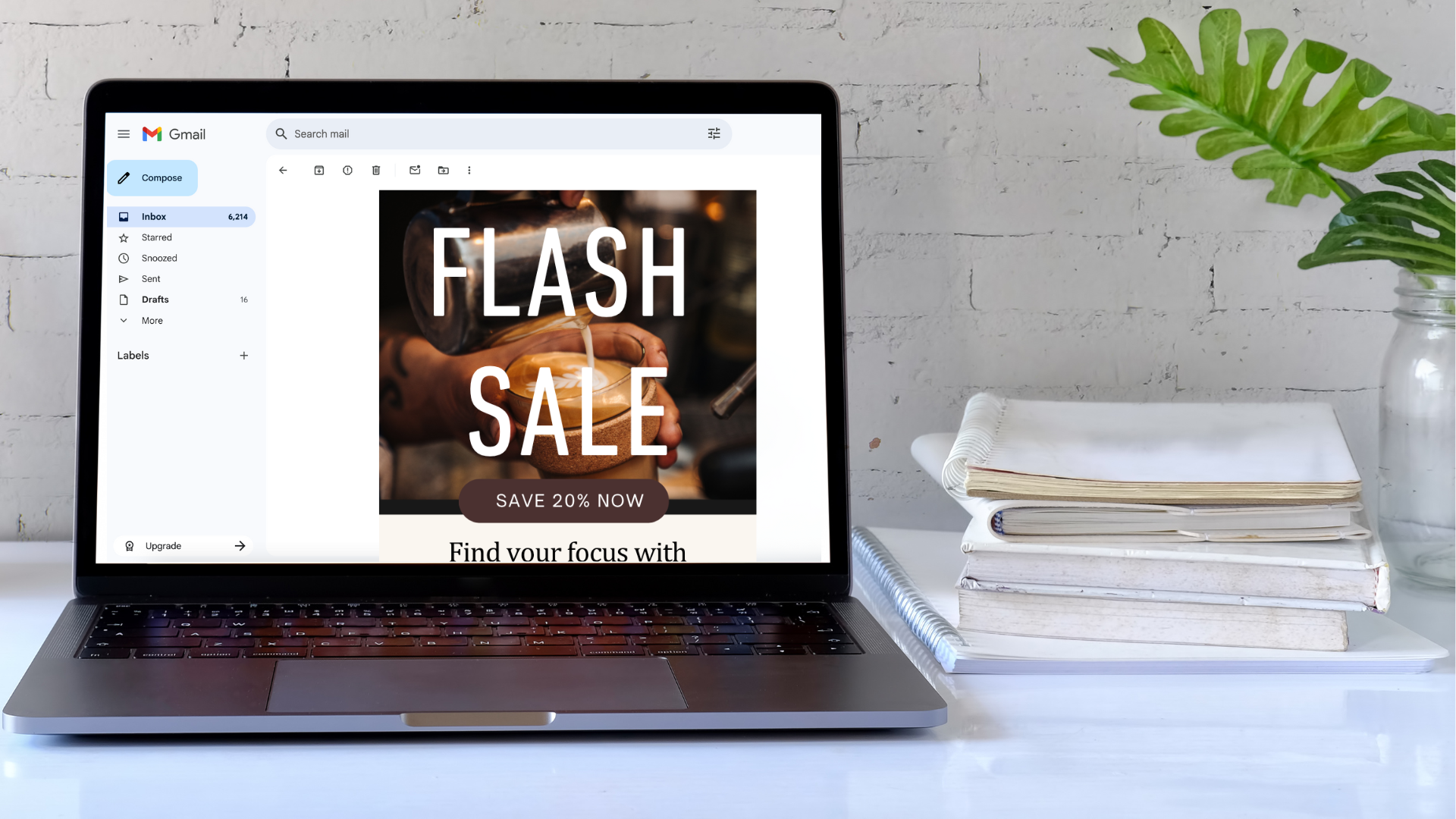 Laptop on a white desk displaying a digital flyer for a flash sale with a coffee brewing scene.