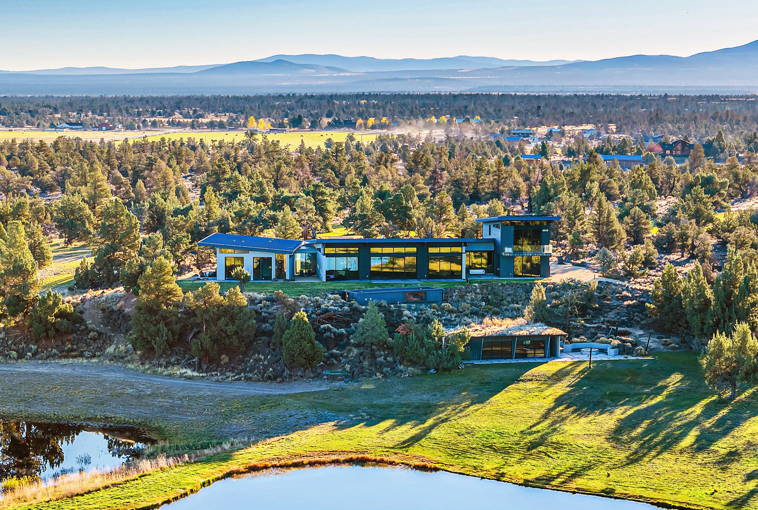 Stunning aerial view of a multi-use complex in Oregon overlooking the Sister mountains. 