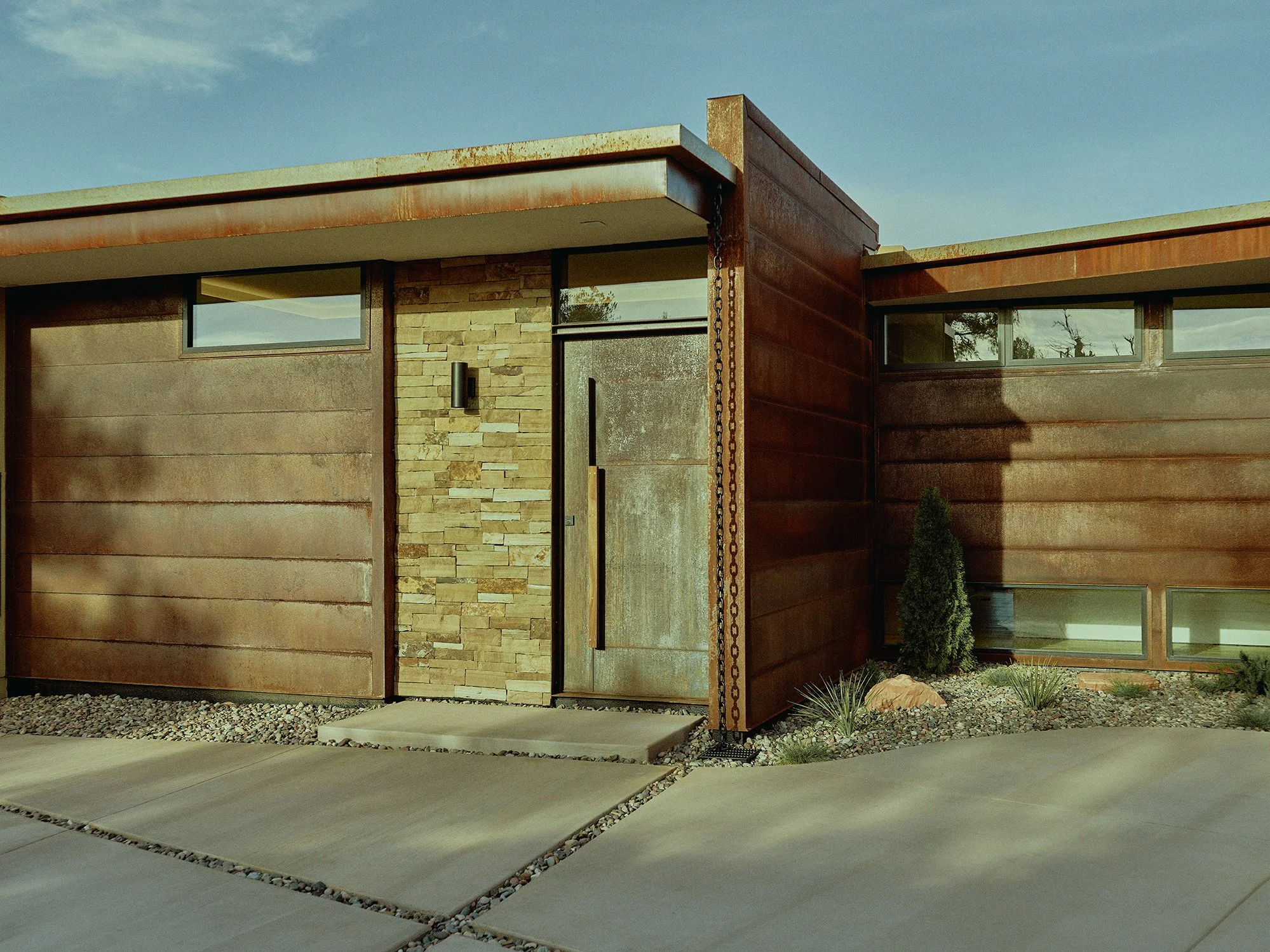 rear entry garage private home rusted copper metal siding