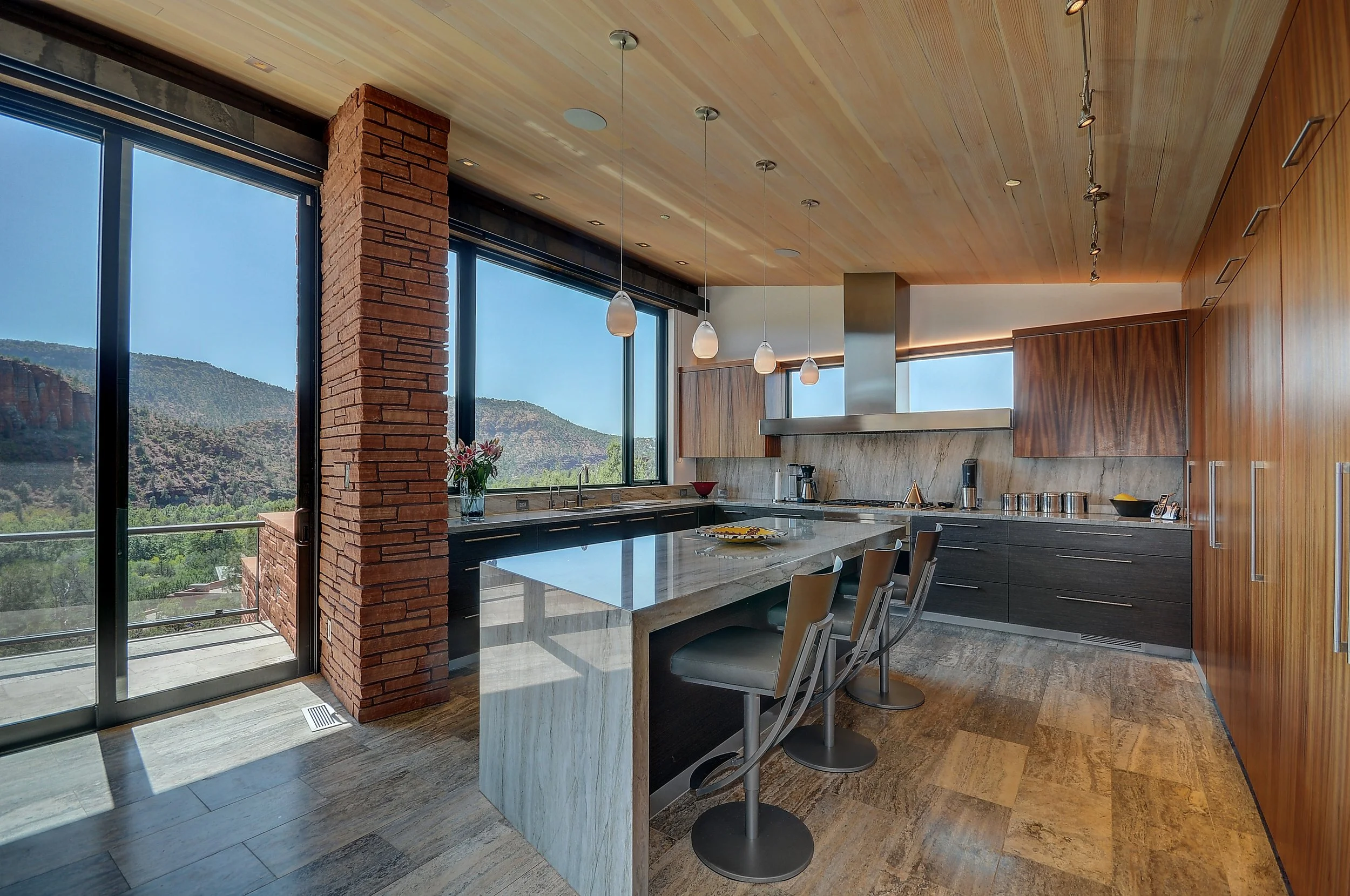 Modern sleek kitchen stone waterfall edge island open concept interior