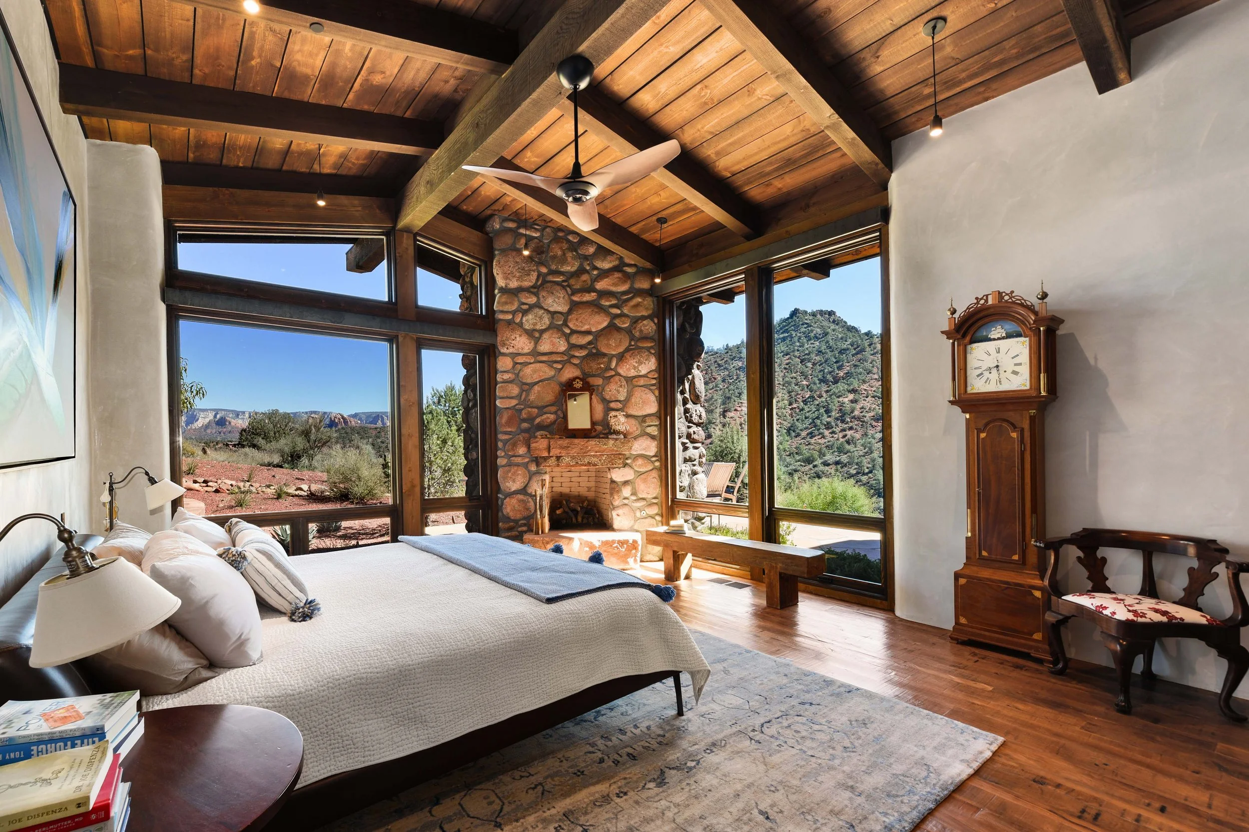 Modern southwestern bedroom suite riverstone fireplace exposed structural timber private residence Sedona