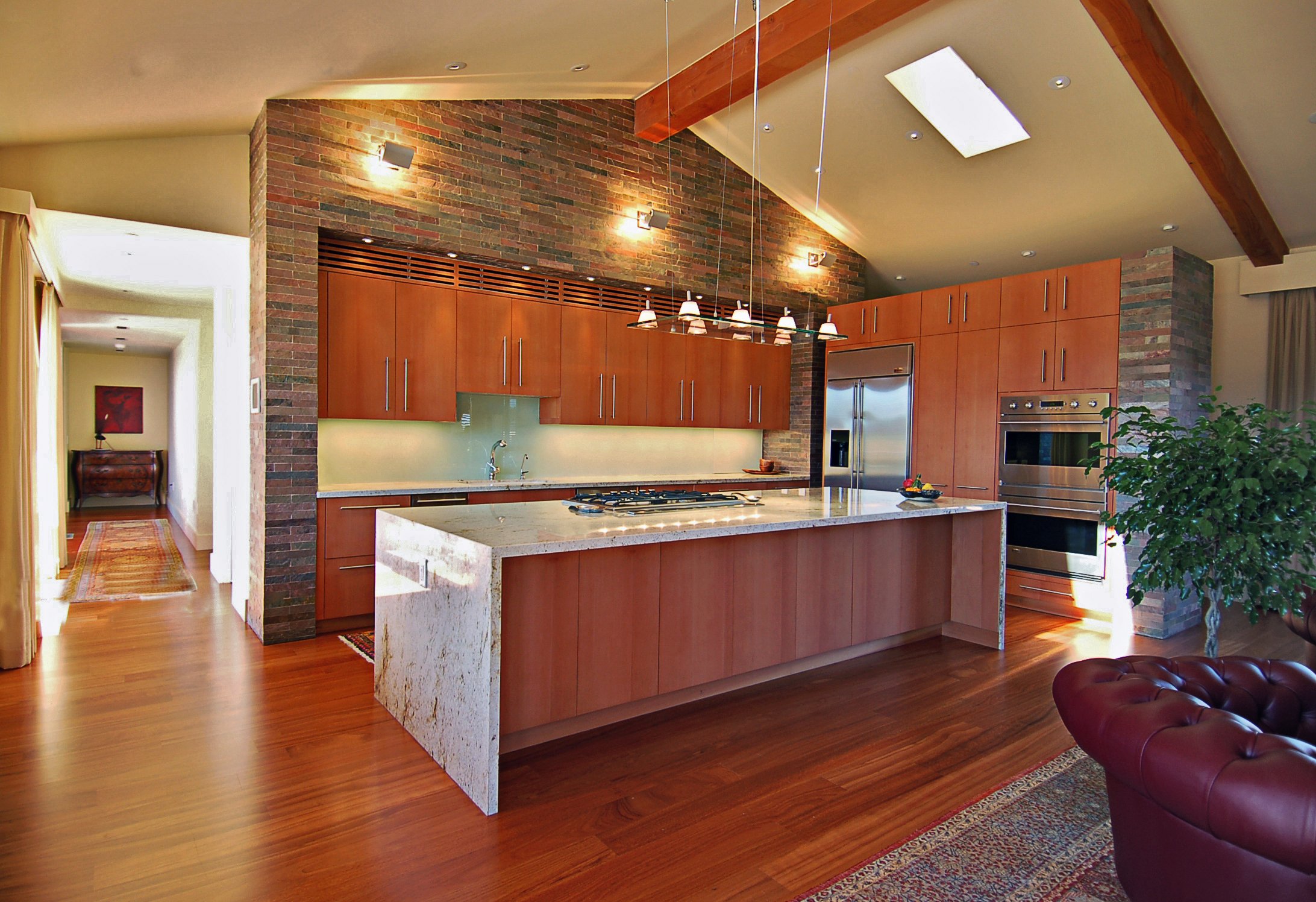waterfall edge kitchen island stone counter top custom hardwood cabinetry