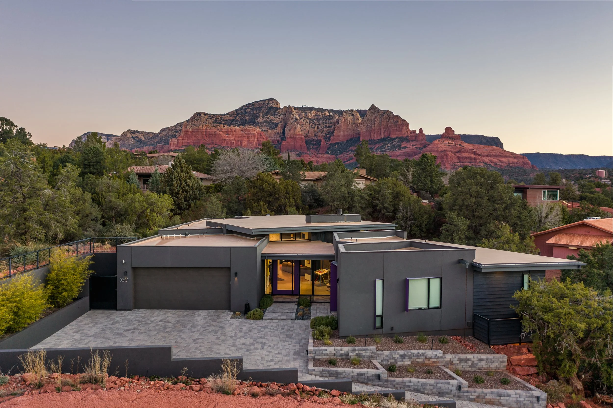 Quiet, terraced entry to a midsize home in downtown Sedona, affixed with pops of purple trim for a unique flare. 
