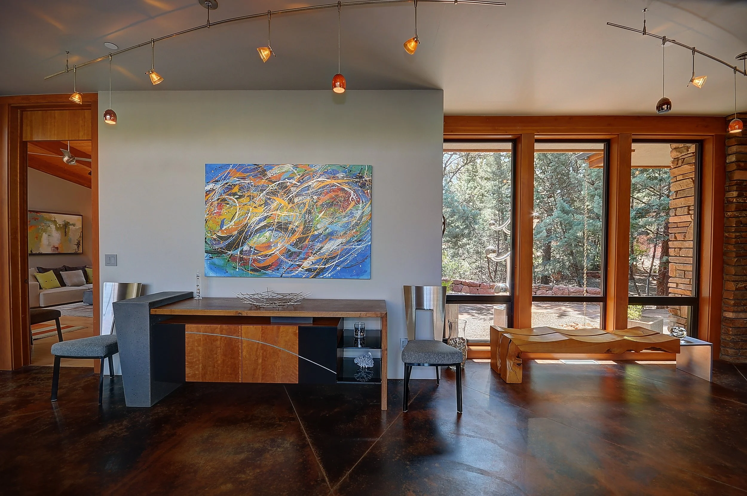 Modern living room with custom fabricated steel and wood credenza, a custom fabricated live-edge wood bench.