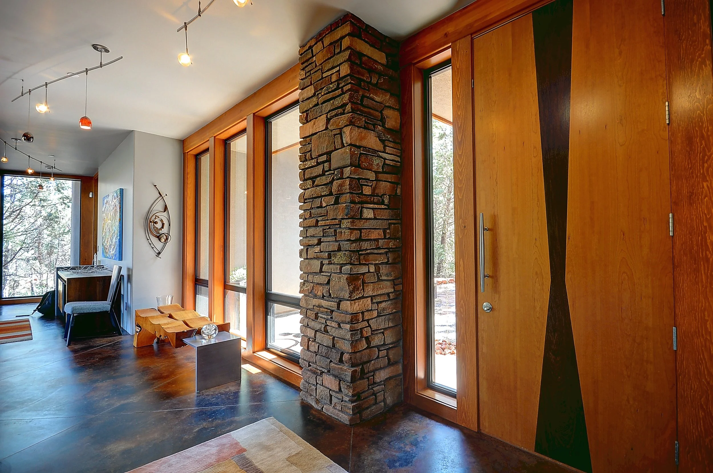 Contemporary luxury residence flagstone wall concrete floor custom fabricated entry door