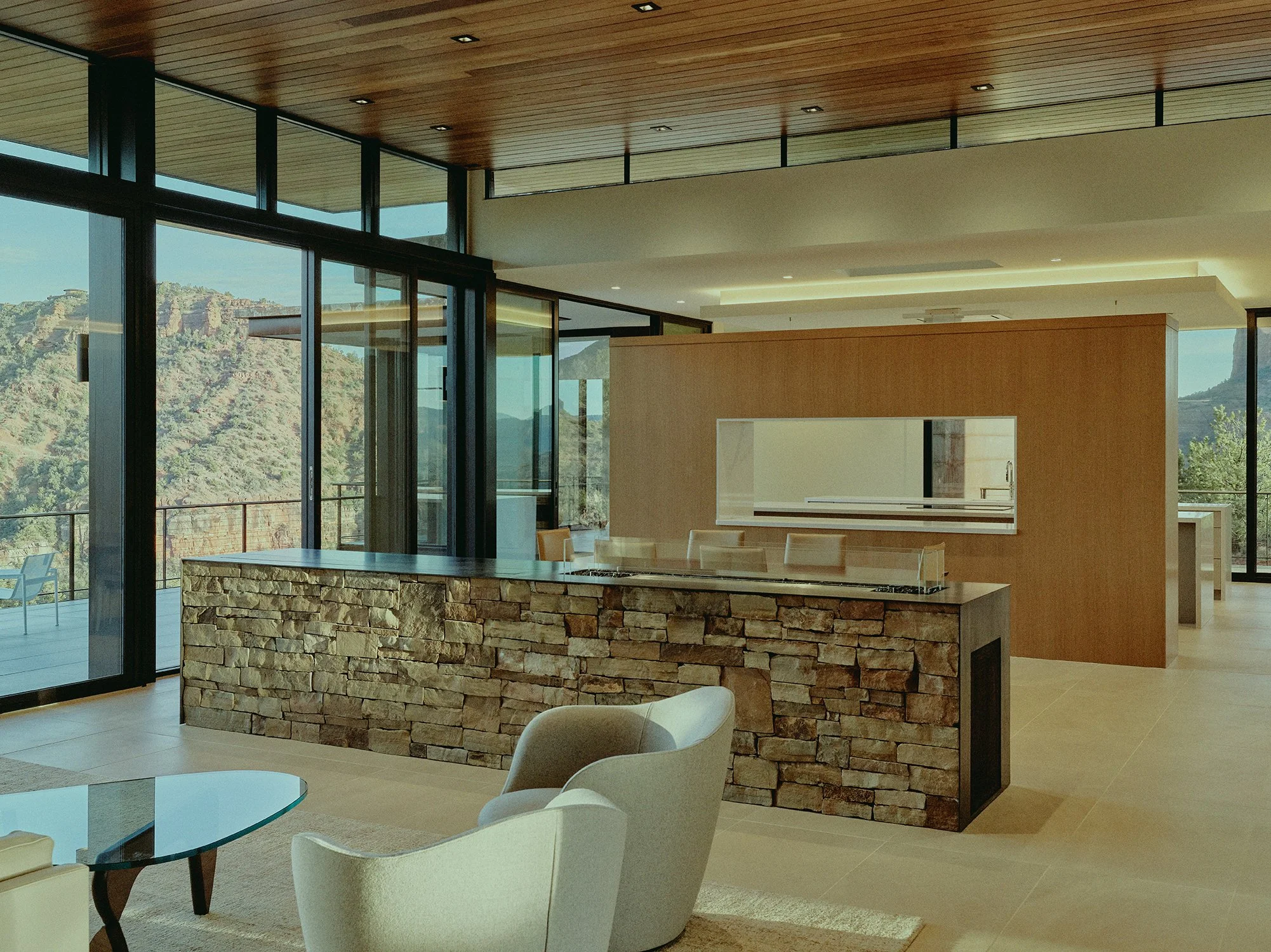 flagstone island open concept living space clerestory windows warm interior design cozy finishes