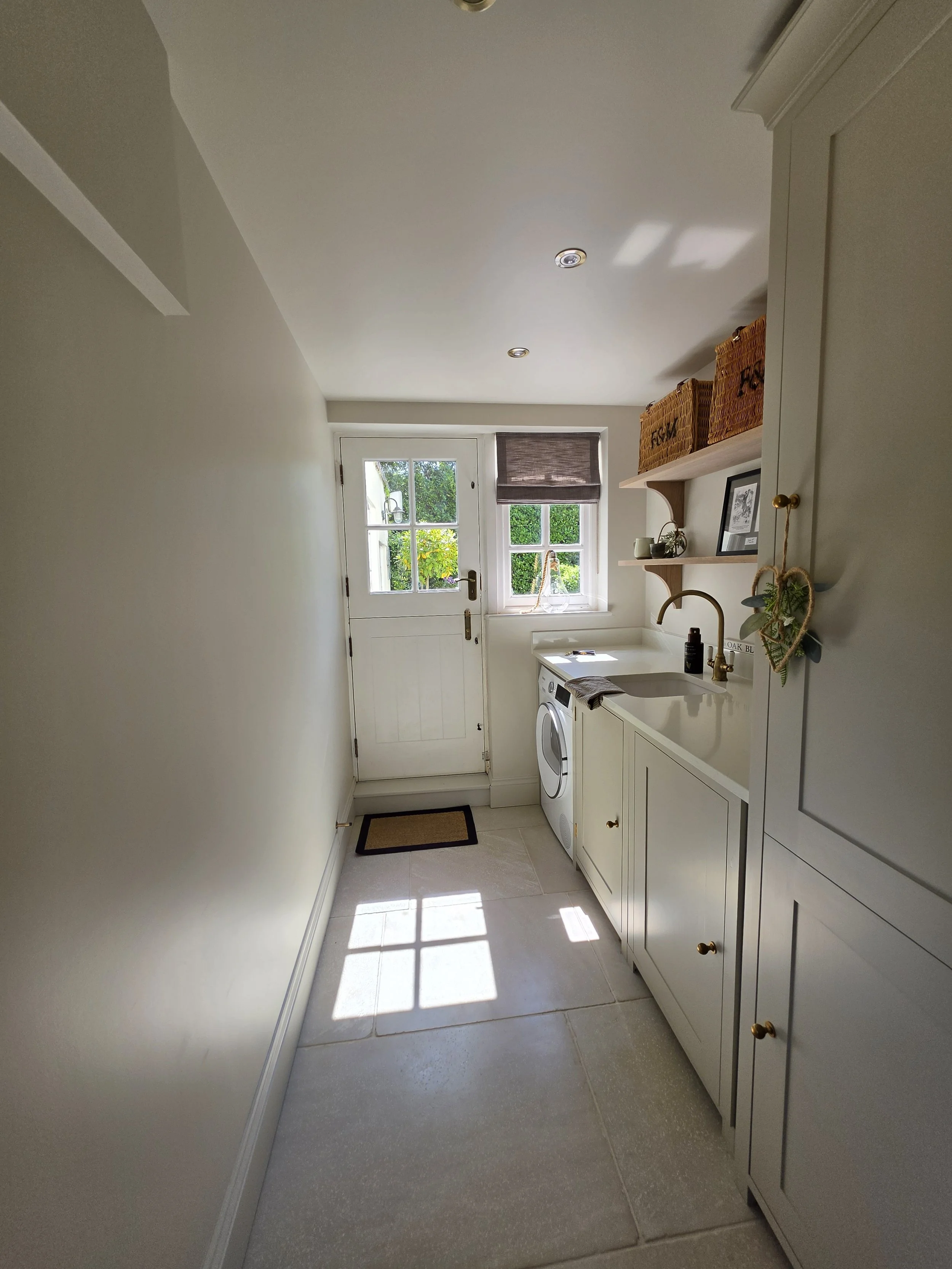 Utility room with stone floor, painted cabinets and glazed back door, Winkfield