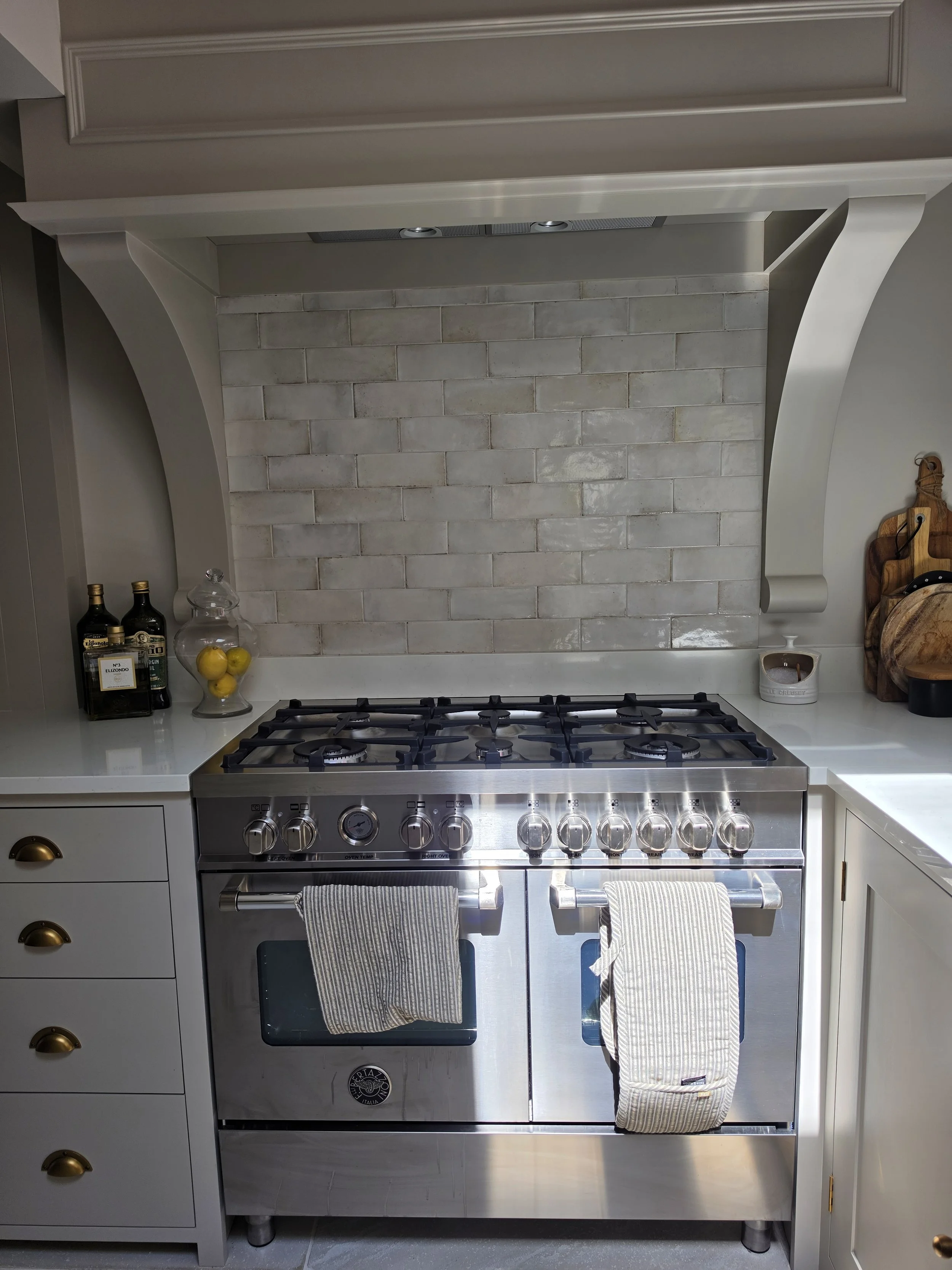 Stainless steel range cooker and tiled splashback in a painted kitchen, Winkfield near Ascot