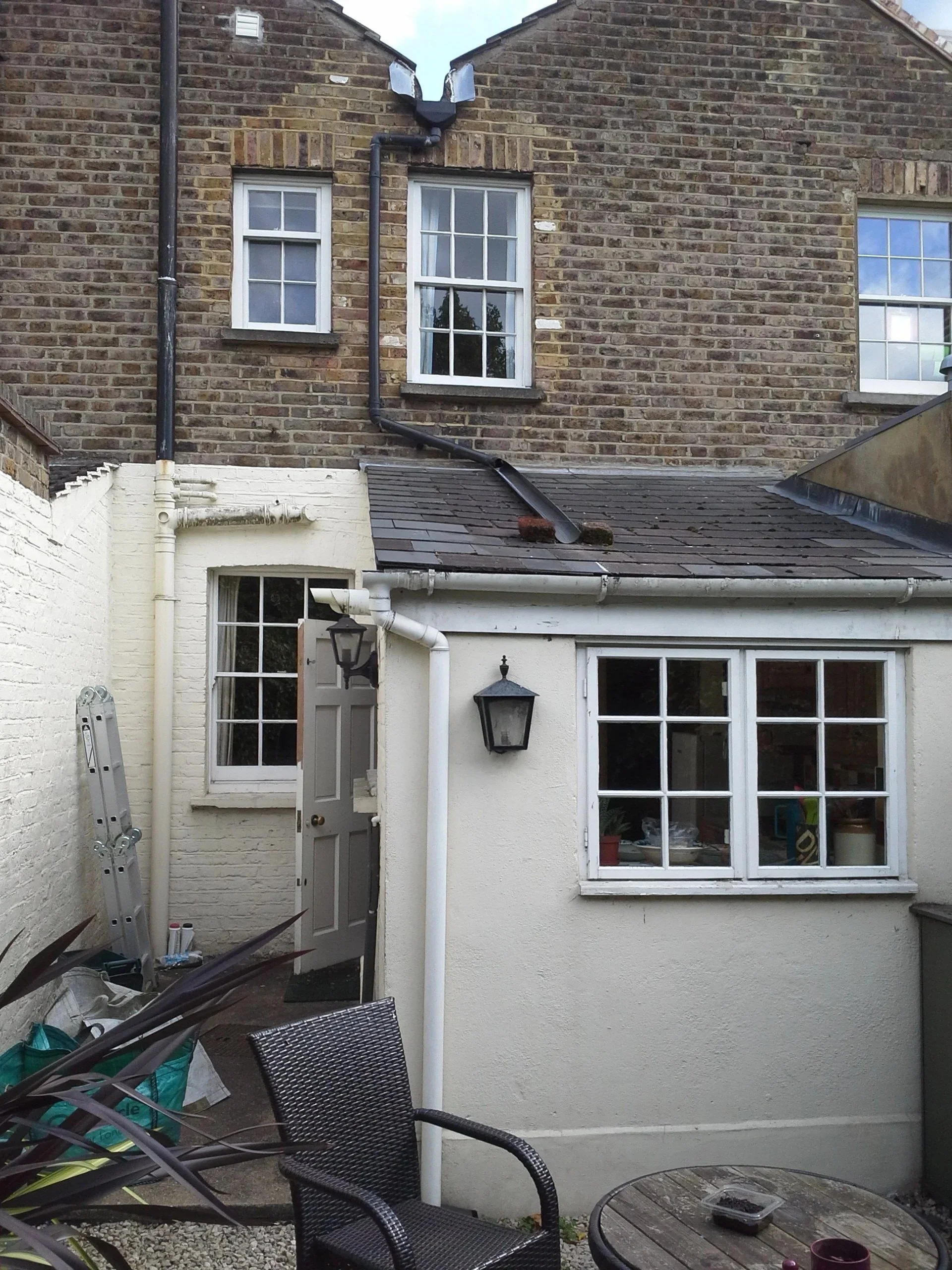 Before: rear of the terraced house with the old pitched-roof extension at a rear kitchen extension on Short Road, Chiswick, W4 by Robin Services.