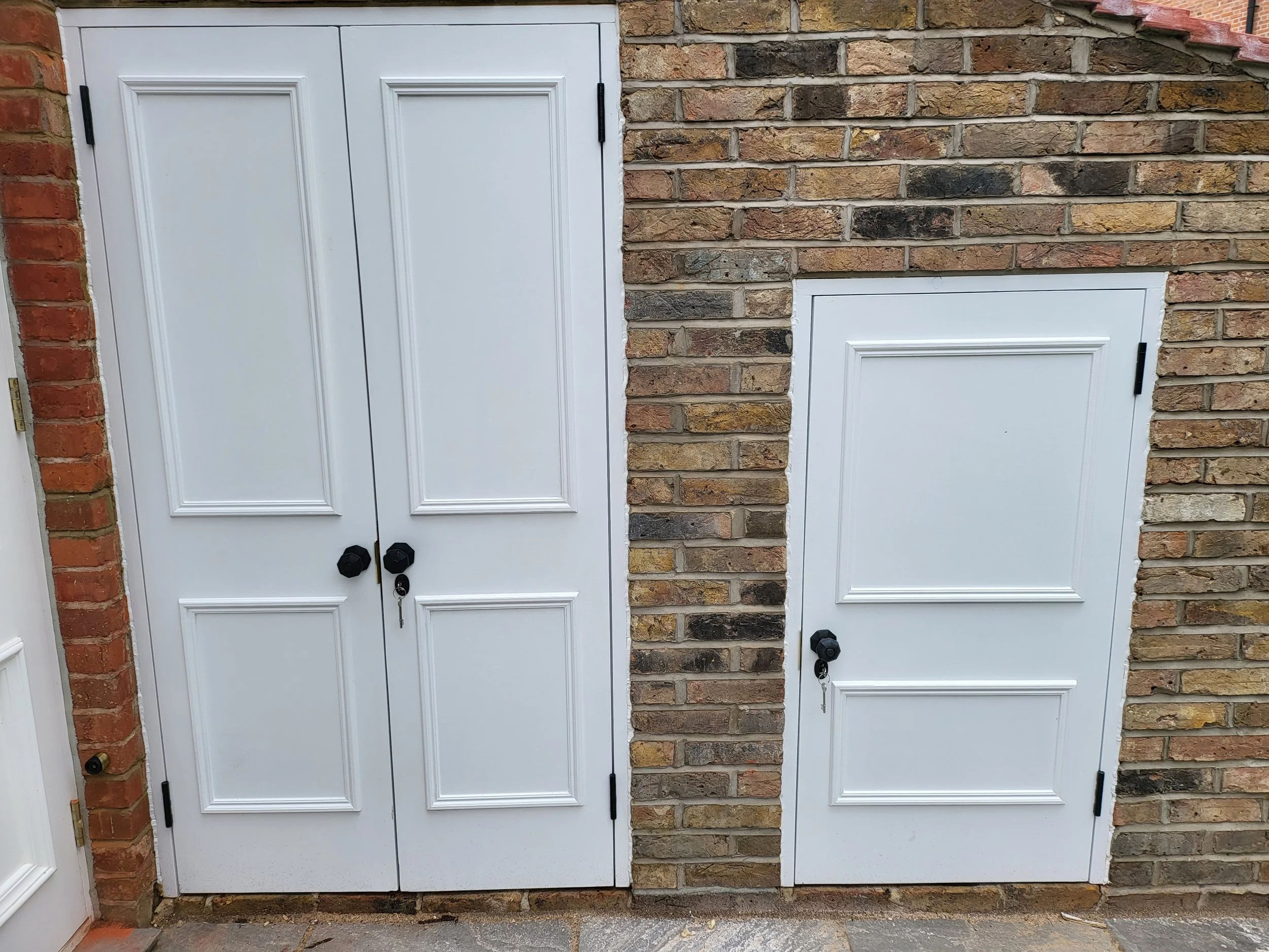 Painted rear store doors in matching brickwork, listed house renovation in Chiswick