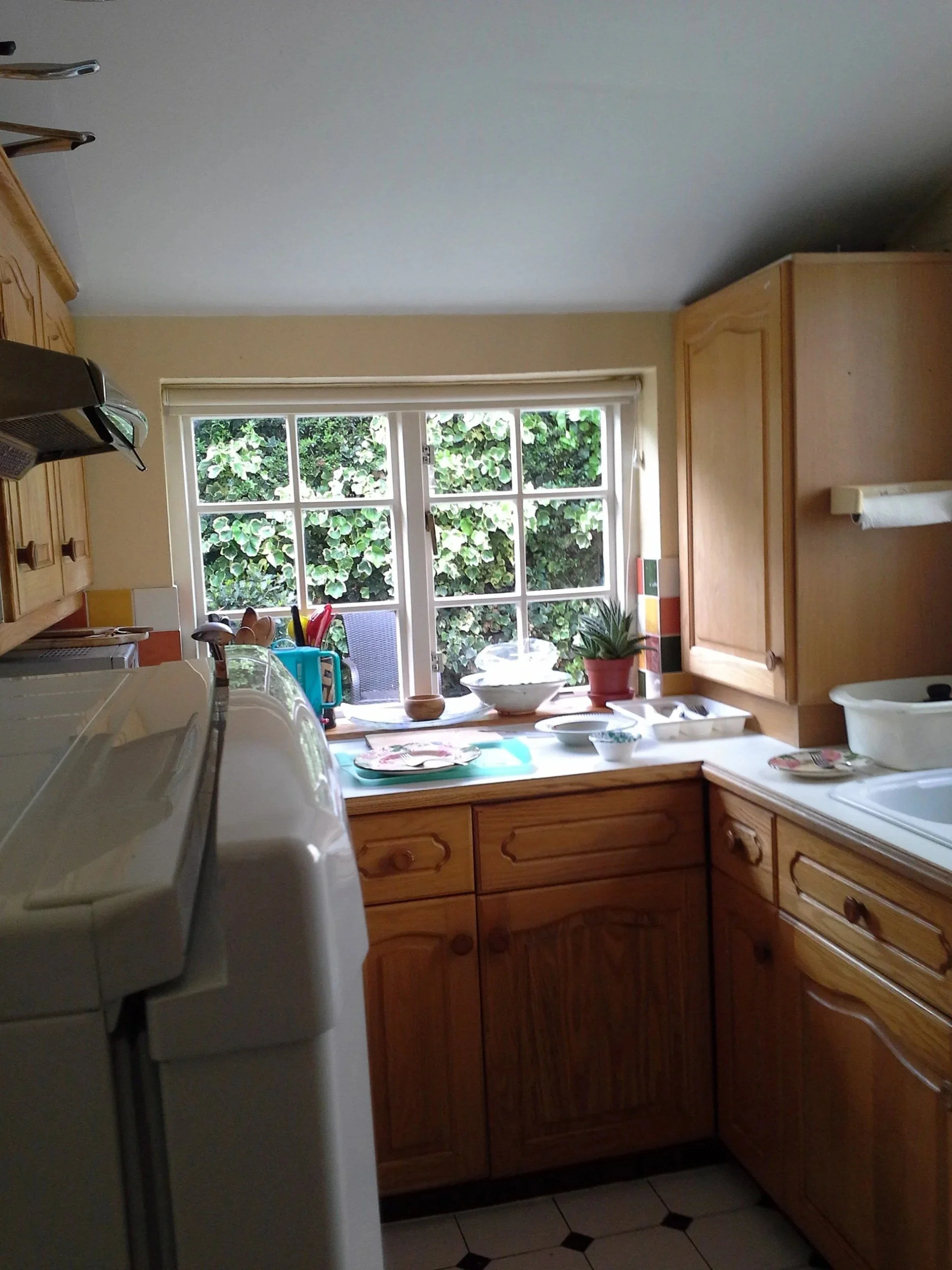 Before: the old kitchen with wooden units and a separate room layout at a rear kitchen extension on Short Road, Chiswick, W4 by Robin Services.