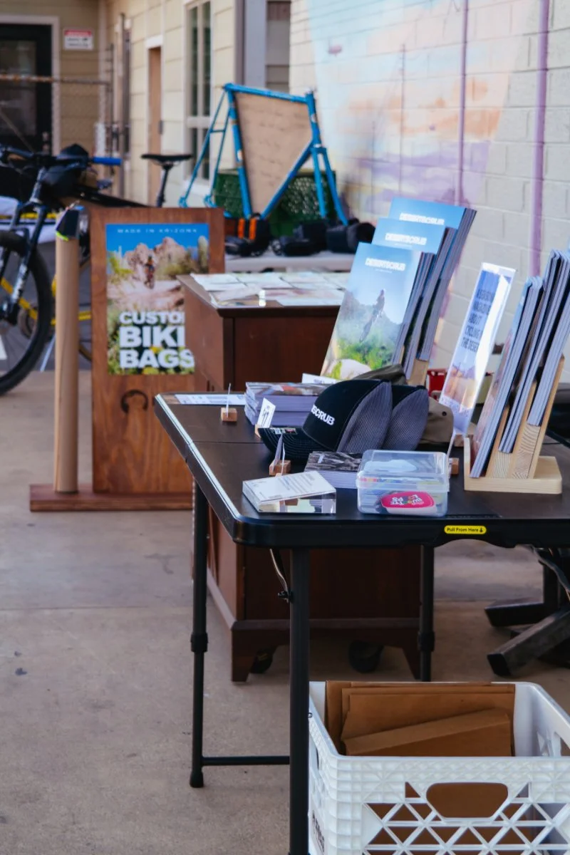 tables of magazines and merch for bicycle event