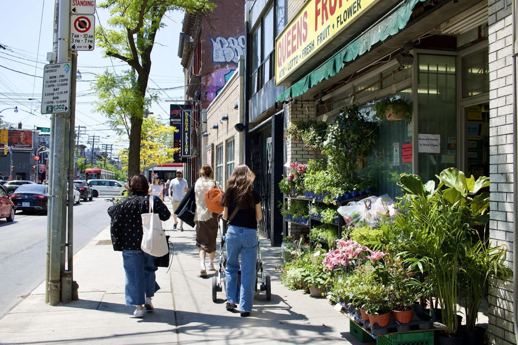 Women walking in front of a flower shop in Toronto