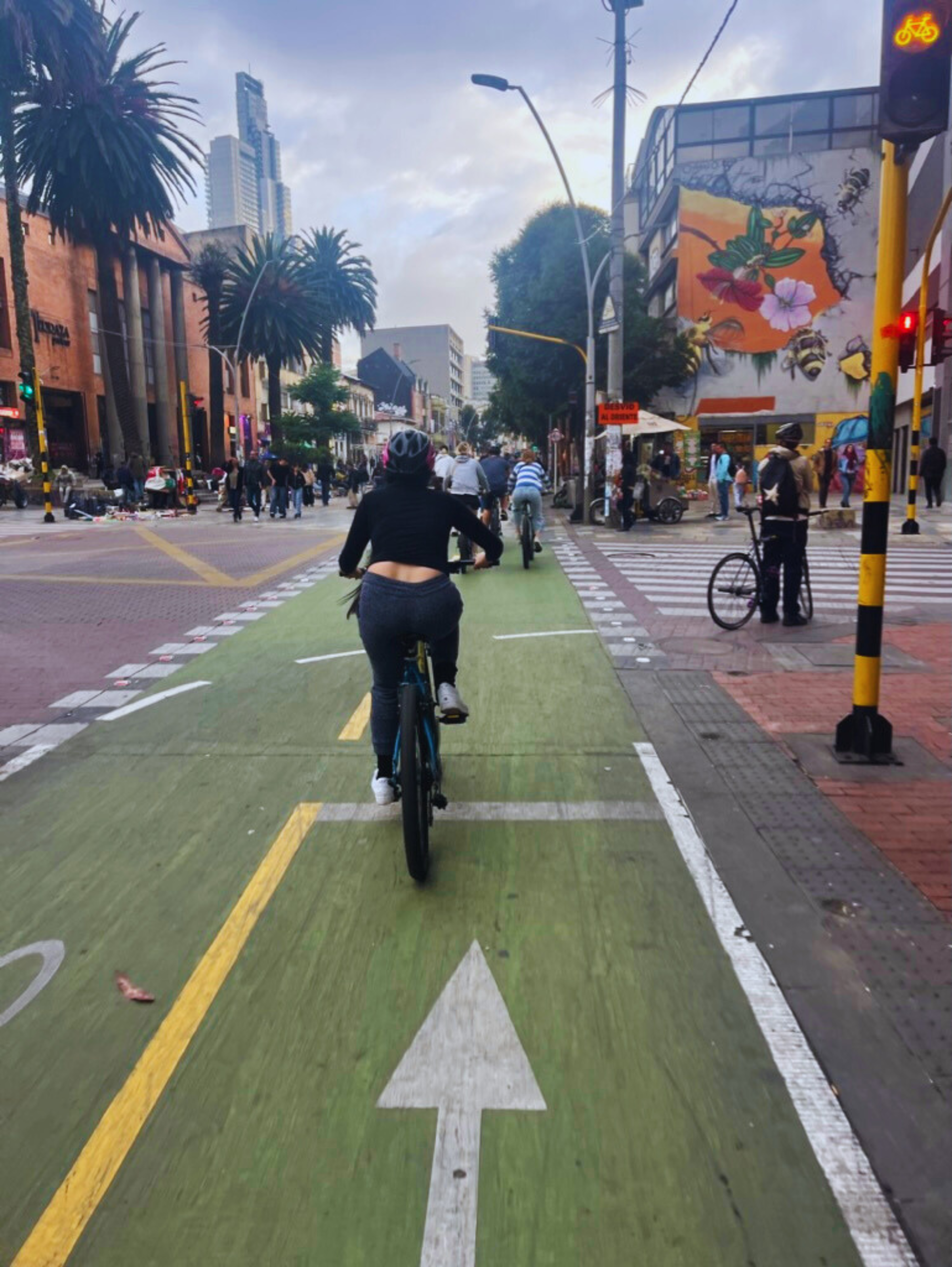 A woman rides a bike in a two-way cycle track in downtown Bogota.