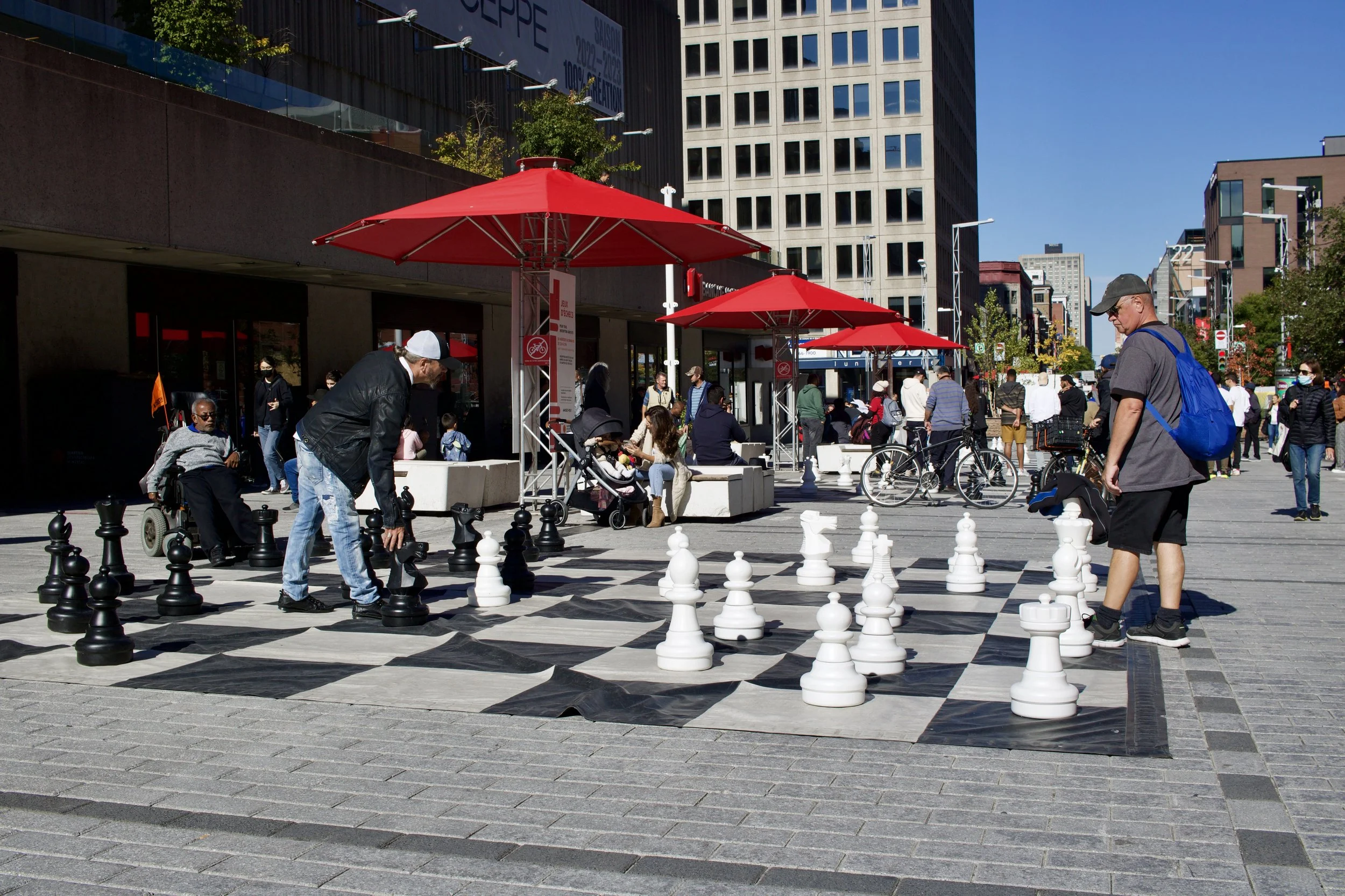 Men playing chess on a street in Montreal, QC