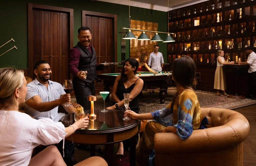 Minimalist boutique hotel desk with a tablet and journals, symbolizing direct booking potential.