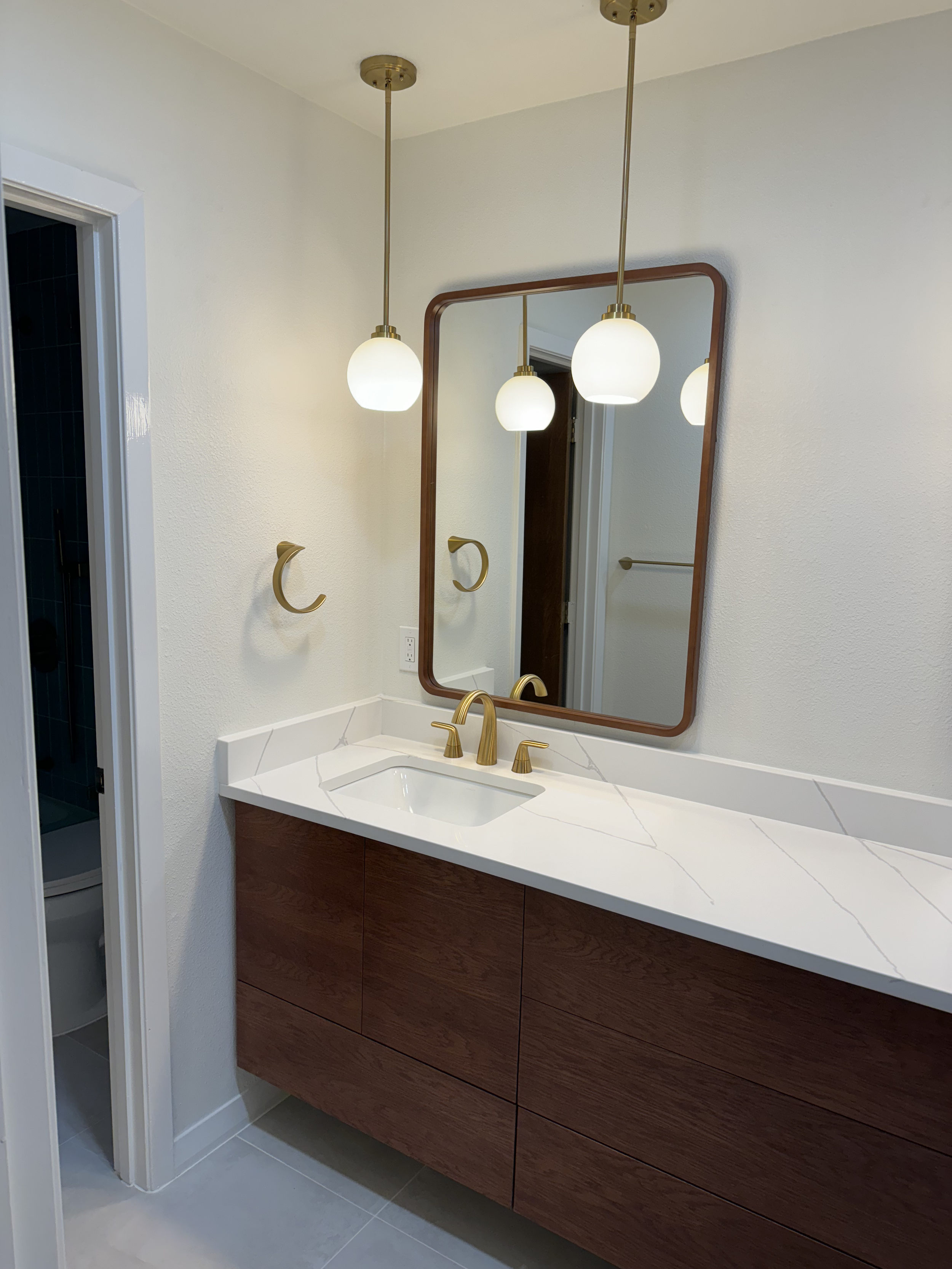 Bathroom sink with gold accent hardware