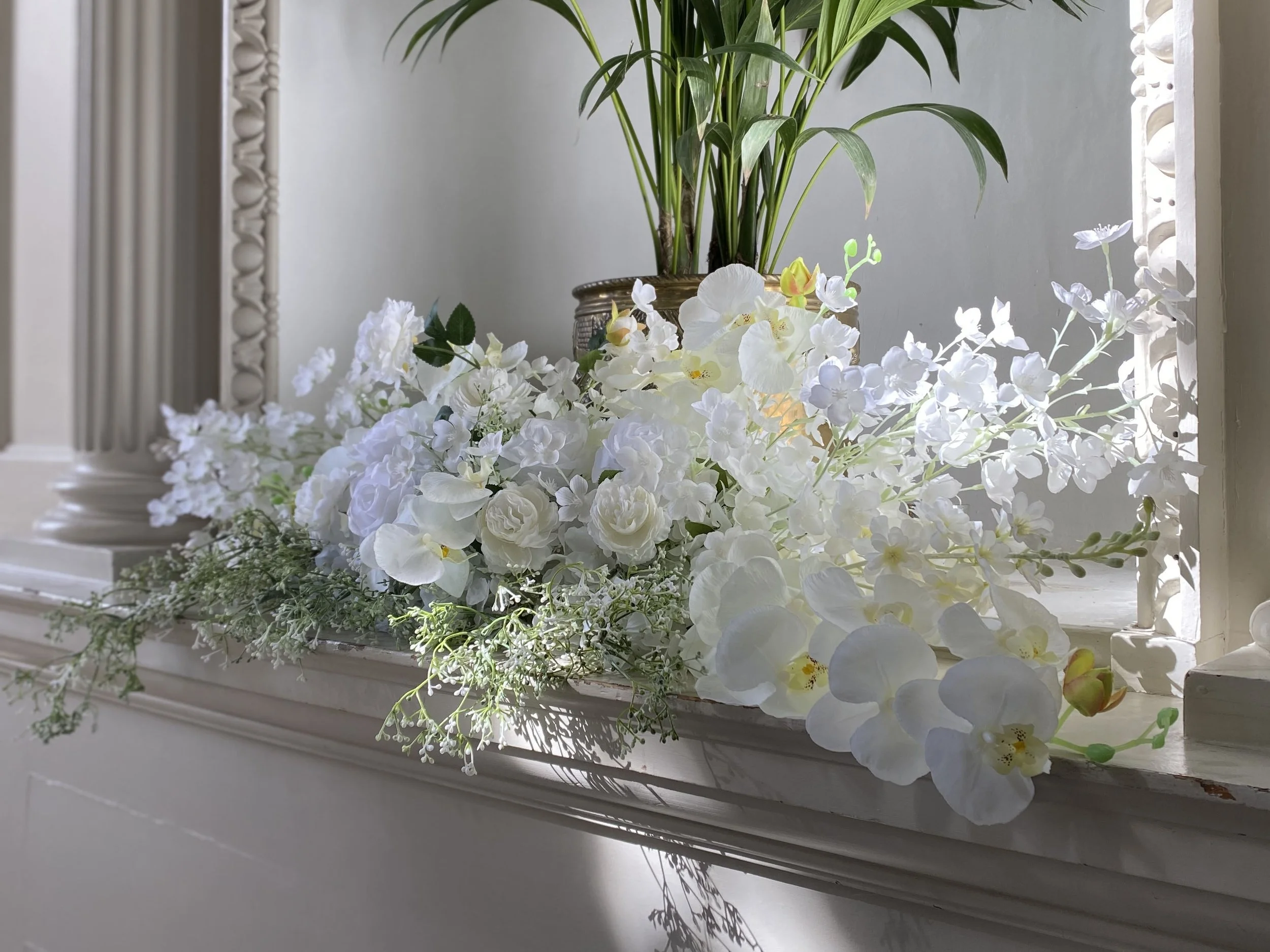 Tiffany floral arrangement used to style a welcome table with white roses and orchids