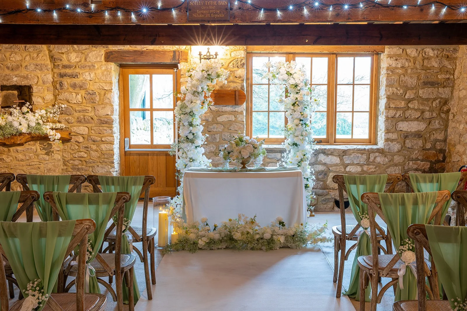 Tiffany broken floral arch with coordinating aisle arrangements styled for ceremony backdrop available from Rosewood & Pearl for luxury wedding décor hire in Buckinghamshire & Oxfordshire.