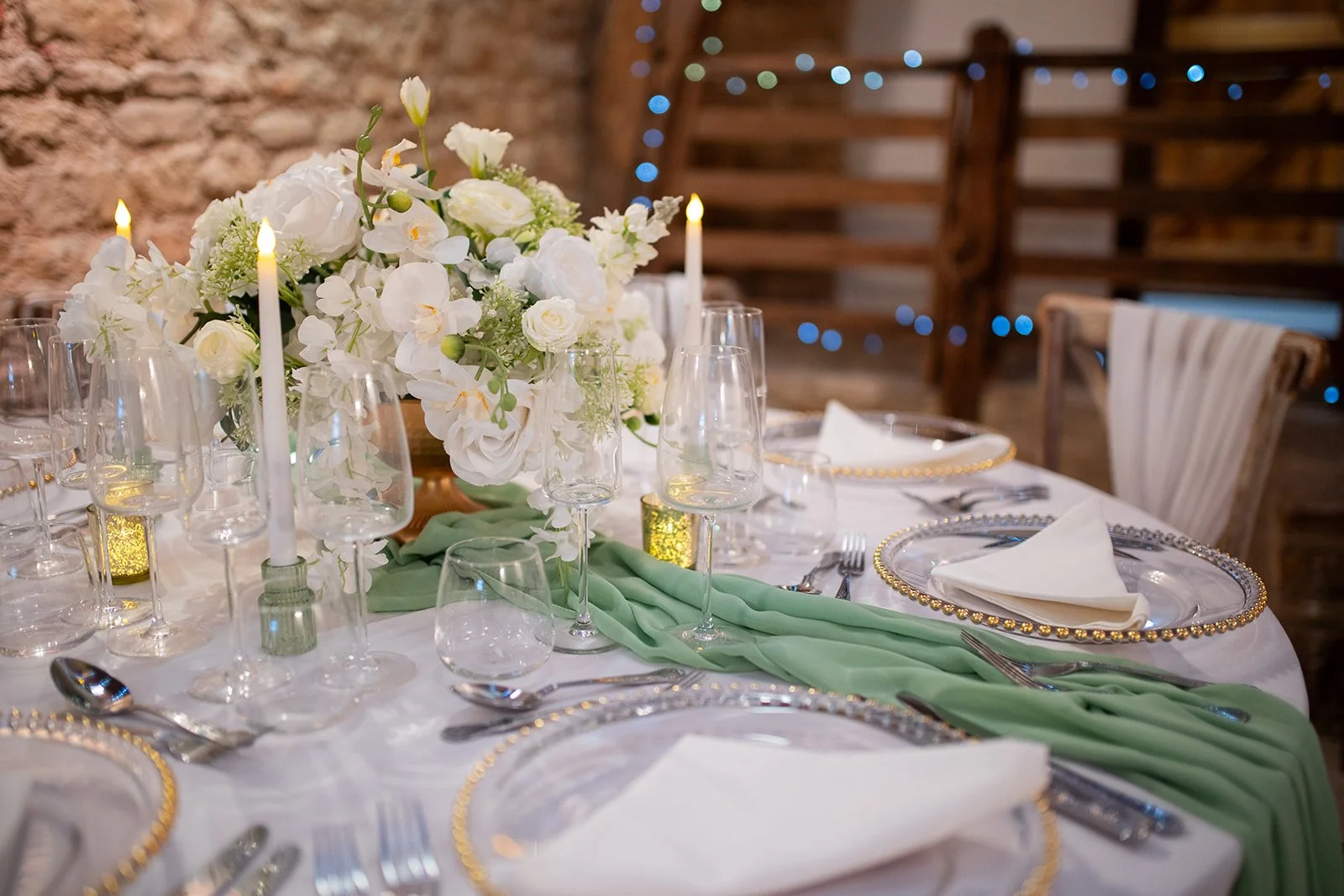Tiffany luxury floral centrepiece with white roses and hydrangeas arranged in a gold bowl for wedding table styling.