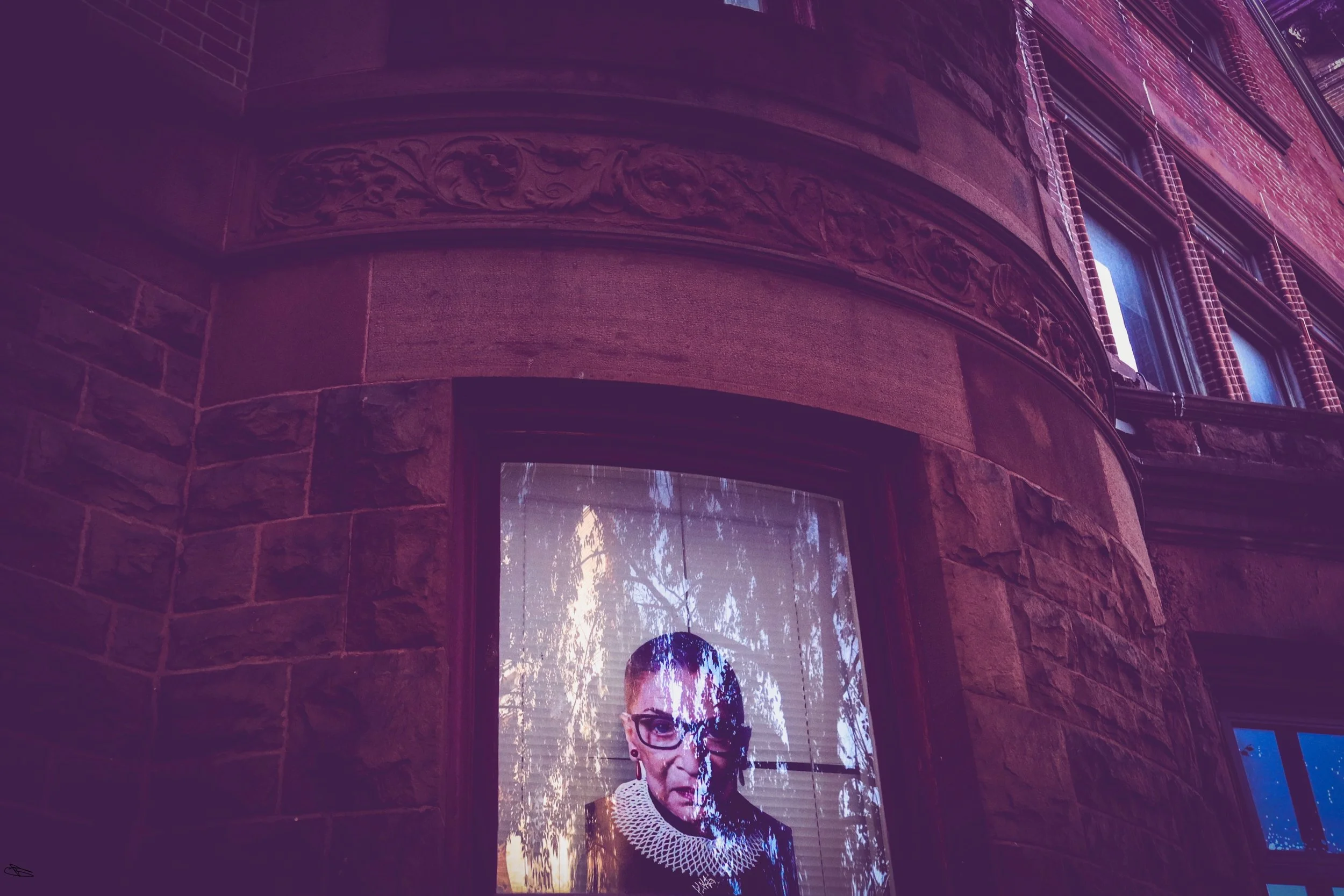 2016 Vibes, 2026

A photo of Ruth Ginsberg stands in someone’s window in a Mount Vernon neighborhood in Baltimore.
