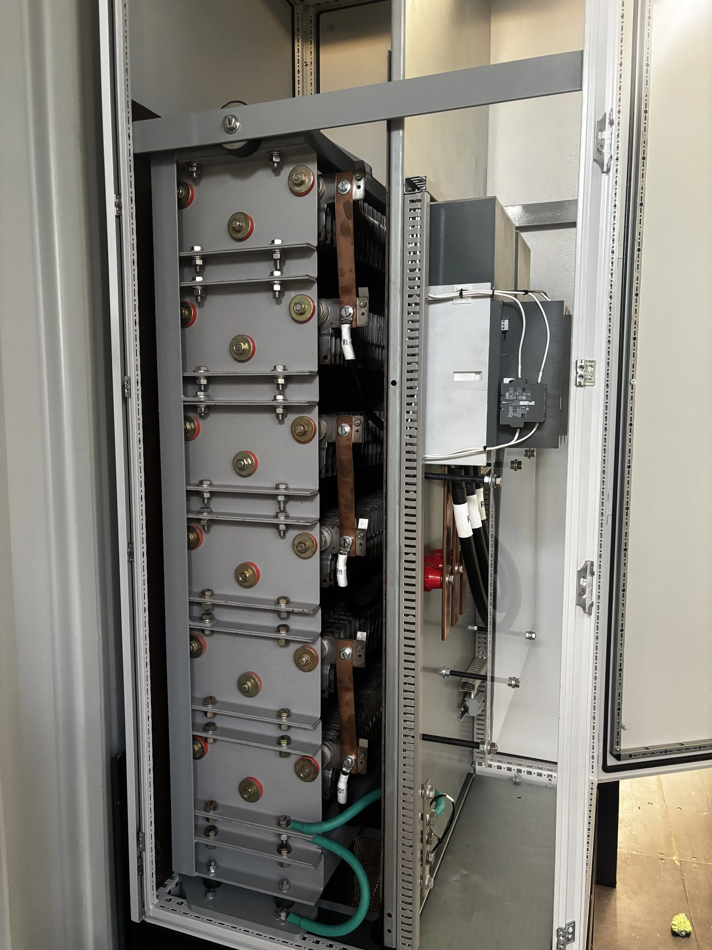 Close-up view of an industrial electrical or electronic control cabinet with various components, circuits, and wiring.