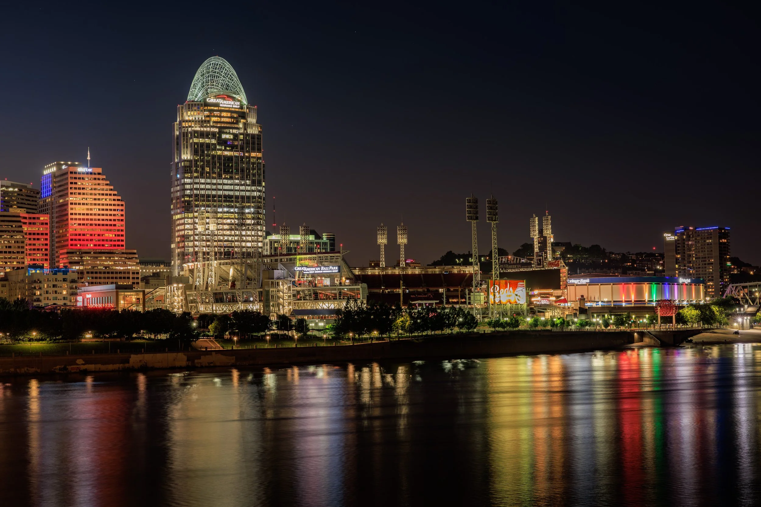 Glowing reflections of the Cincinnati skyline dance across the Ohio River.