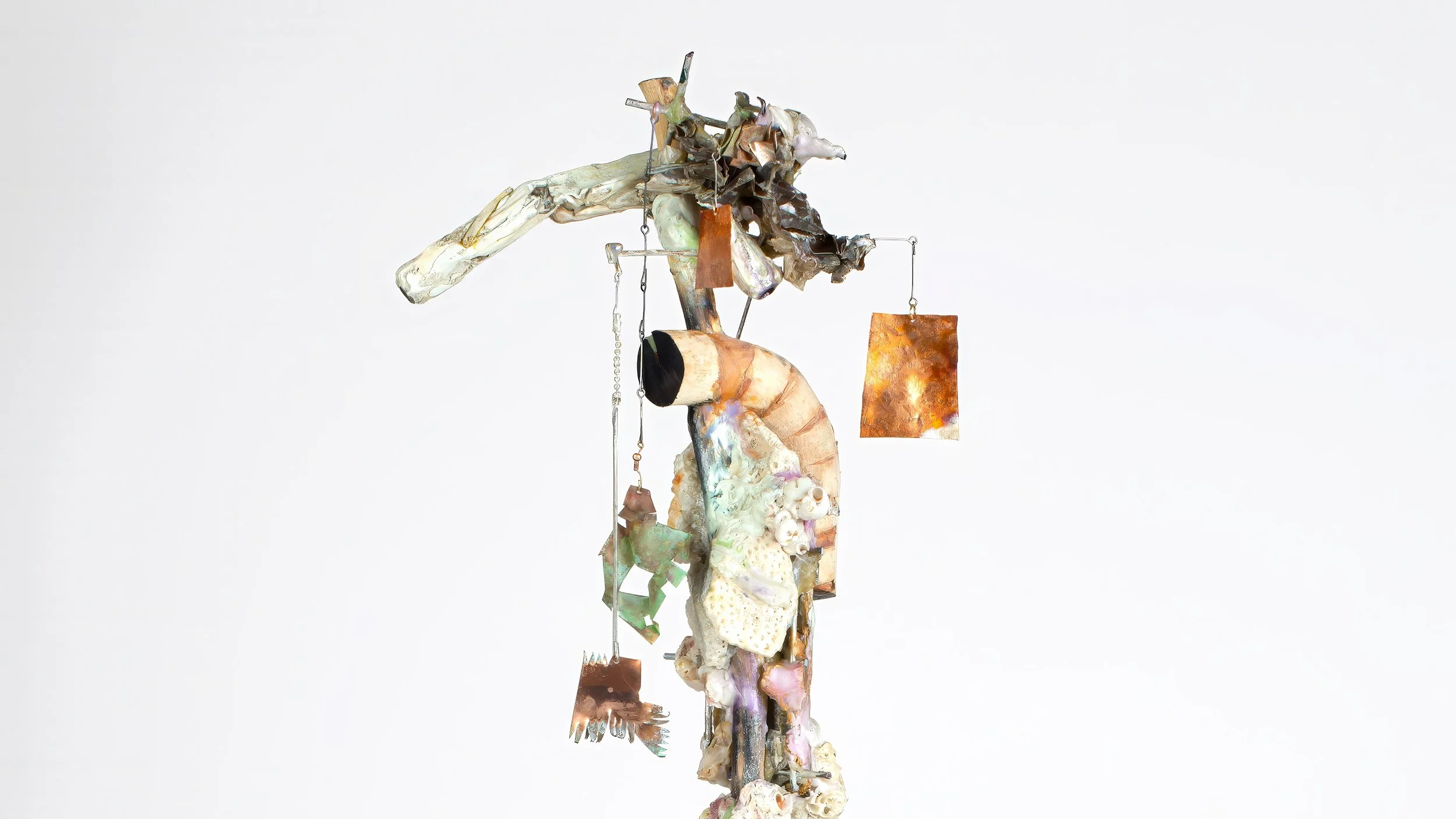 Yasue Maetake Three-Legged Idols detail: complex vertical assemblage with organic forms, shells, and hanging rectangular copper plates against white background