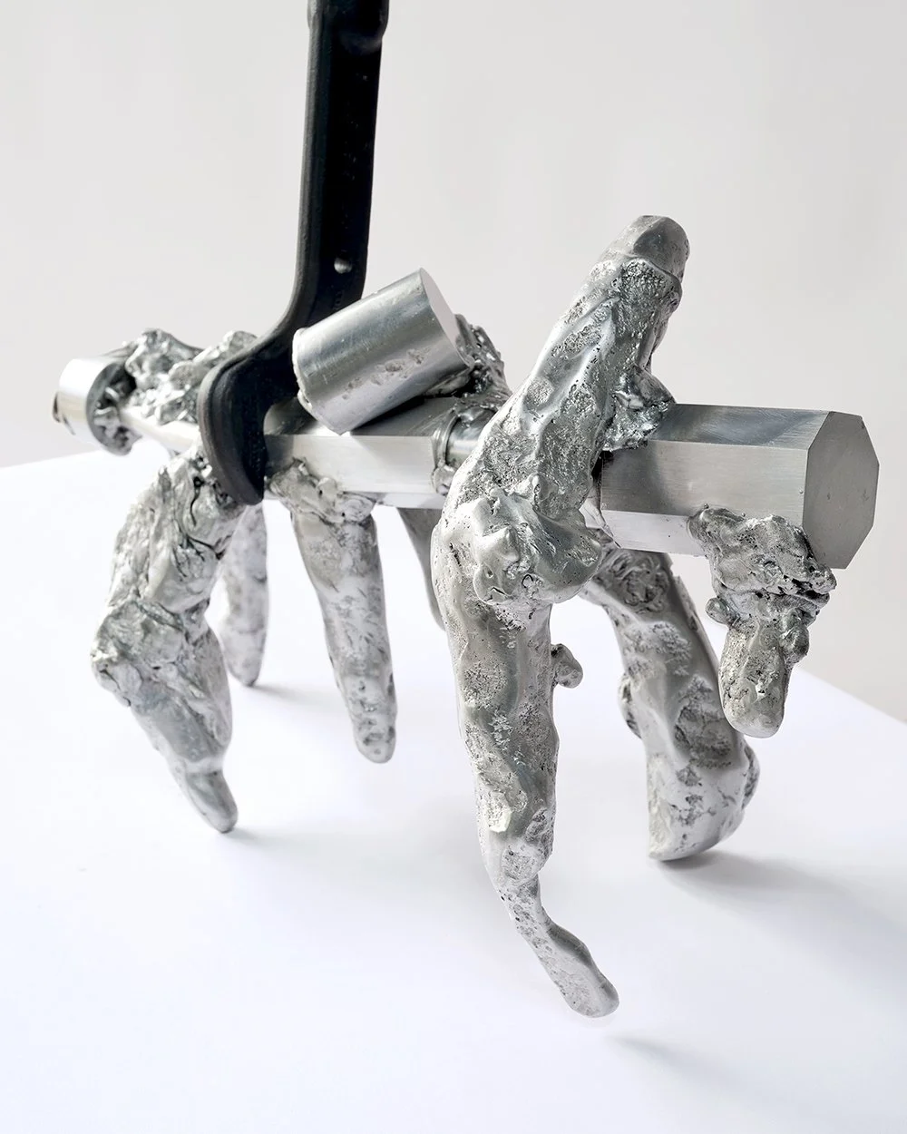 A sculpture resembling a horse, made of metallic and plastic materials with a black handlebar and silver parts, crafted in a modern, abstract style.