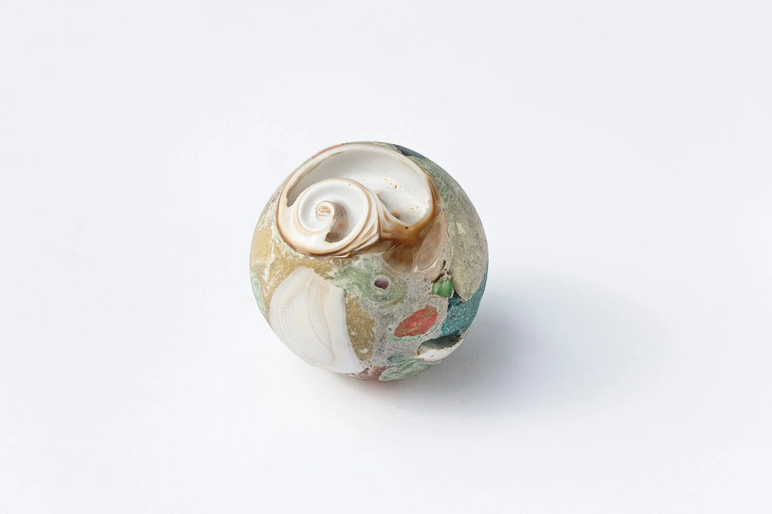 Untitled (Spiral) 2024 Proprietary blend made from an epoxy embedded seashell, coral, fossil, alabaster, sea glass, assorted quartz, and ground marble 7.3 x 7.3 cm 2 7/8 x 2 7/8 in