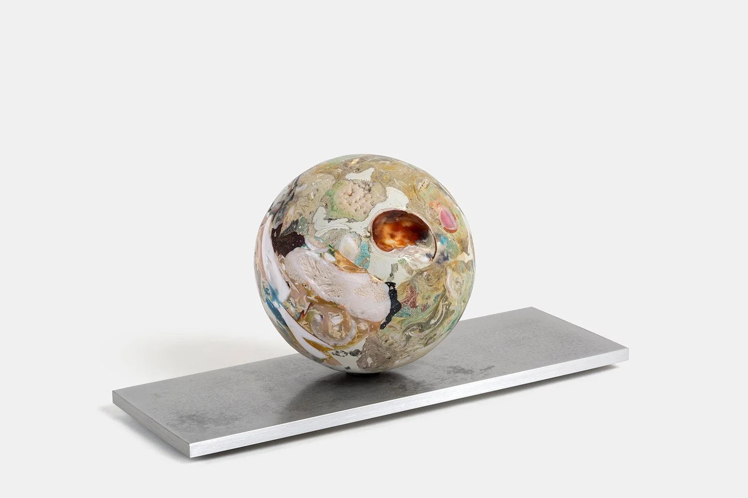 Orb Materia—Cocoon
(2026)
Hand-carved proprietary compound (marine calcite, polymer, quartz, marble) on aluminum base. H 5 x 9 1/2 x 4 1/4 in