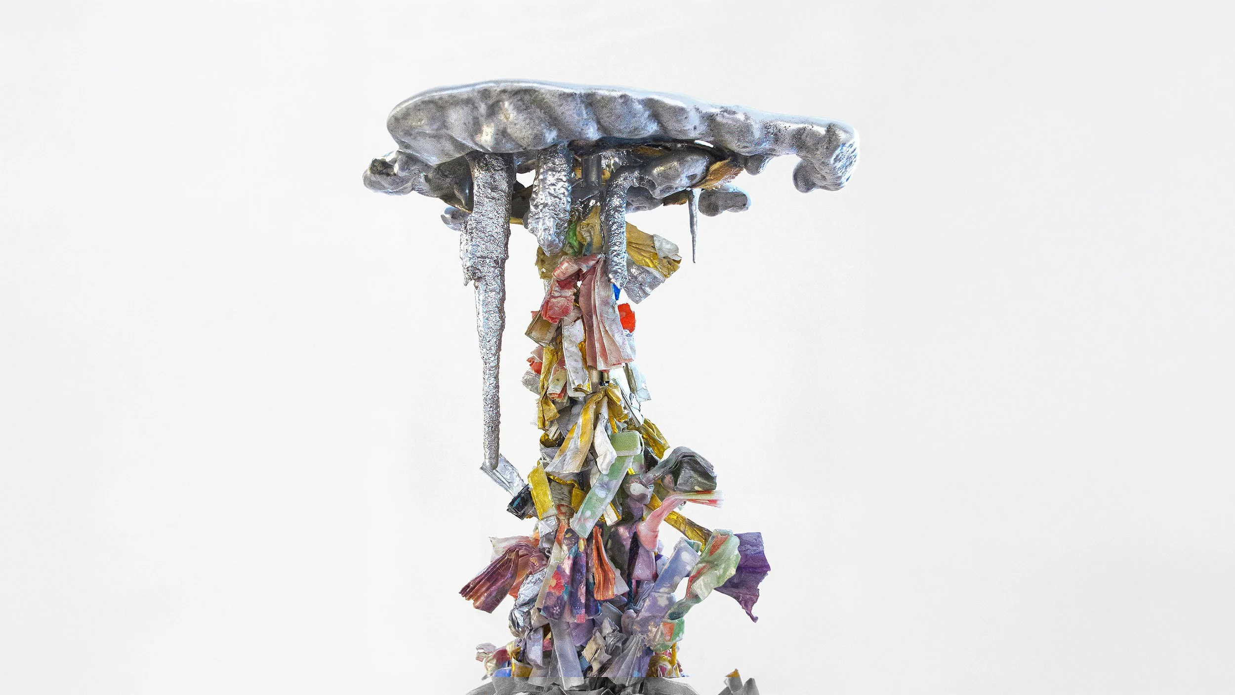 Yasue Maetake Three-Legged Idols detail: close-up of silver metallic top with dripping forms and cascading multicolored folded elements hanging below against white background