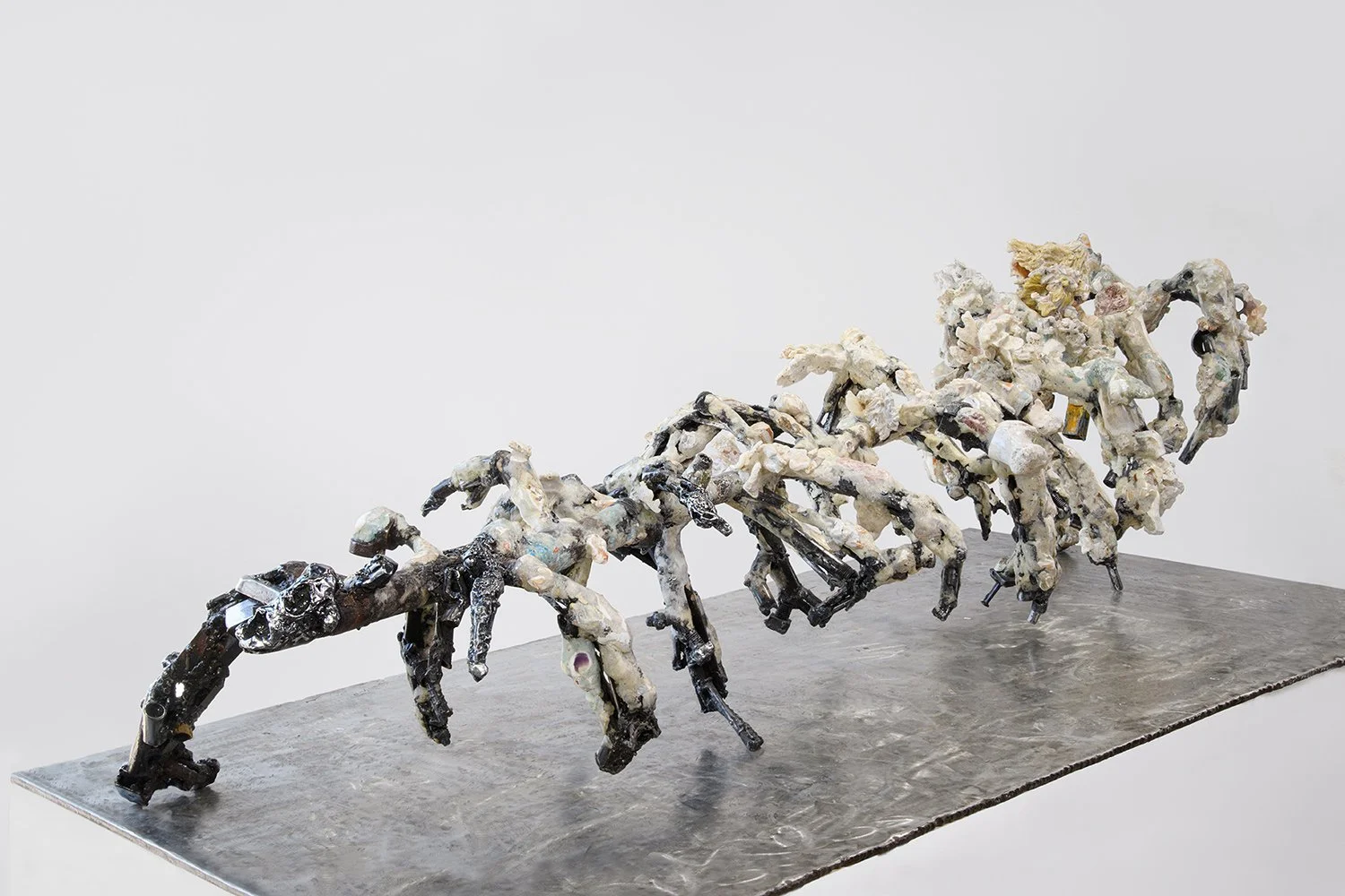Yasue Maetake's sculpture Mare Fecunditatis – resurrection, 2025. Wide angled installation view of the elongated multi-limbed hybrid sculpture showing the full sprawling length of chaotic creature-like organic forms in white and gray tones with black