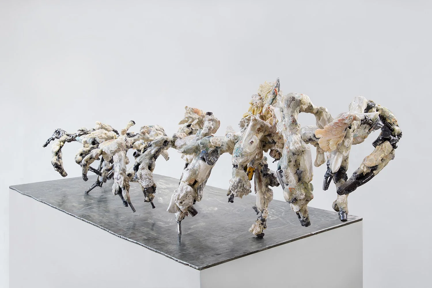 Yasue Maetake, Mare Fecunditatis - resurrection, 2025. Long horizontal hybrid sculpture with a chaotic procession of interconnected organic forms in white, gray, and muted tones, highly textured surfaces, placed on a dark metal base.