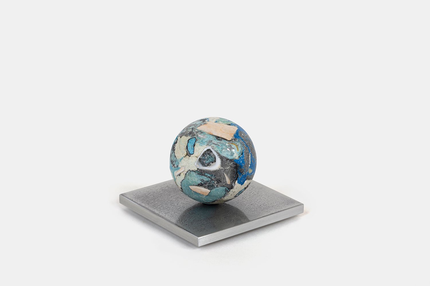 Orb Materia—Blue Float
(2026)
Hand-carved proprietary compound (marine calcite, polymer, marble) on aluminum base. H 2 5/8 x 3 1/2  x 3 1/2 in