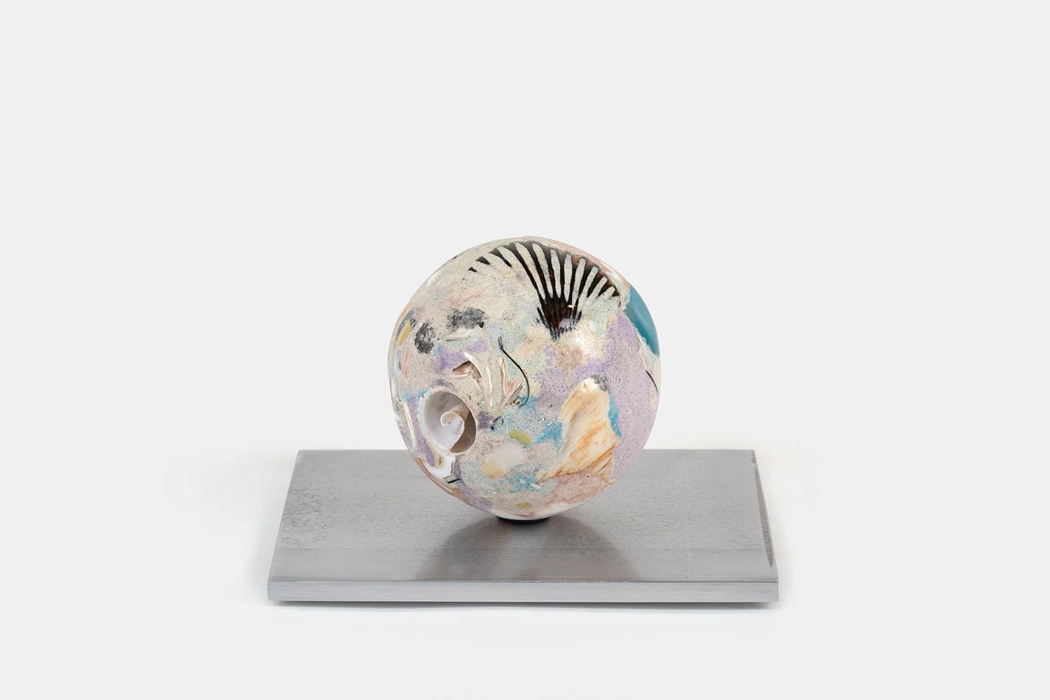 Orb Materia—Cyclone-glyph
(2026)
Hand-carved proprietary compound (marine calcite, agate, polymer, marble) on aluminum base. H 3 5/8 x 6 x 4 1/2 in