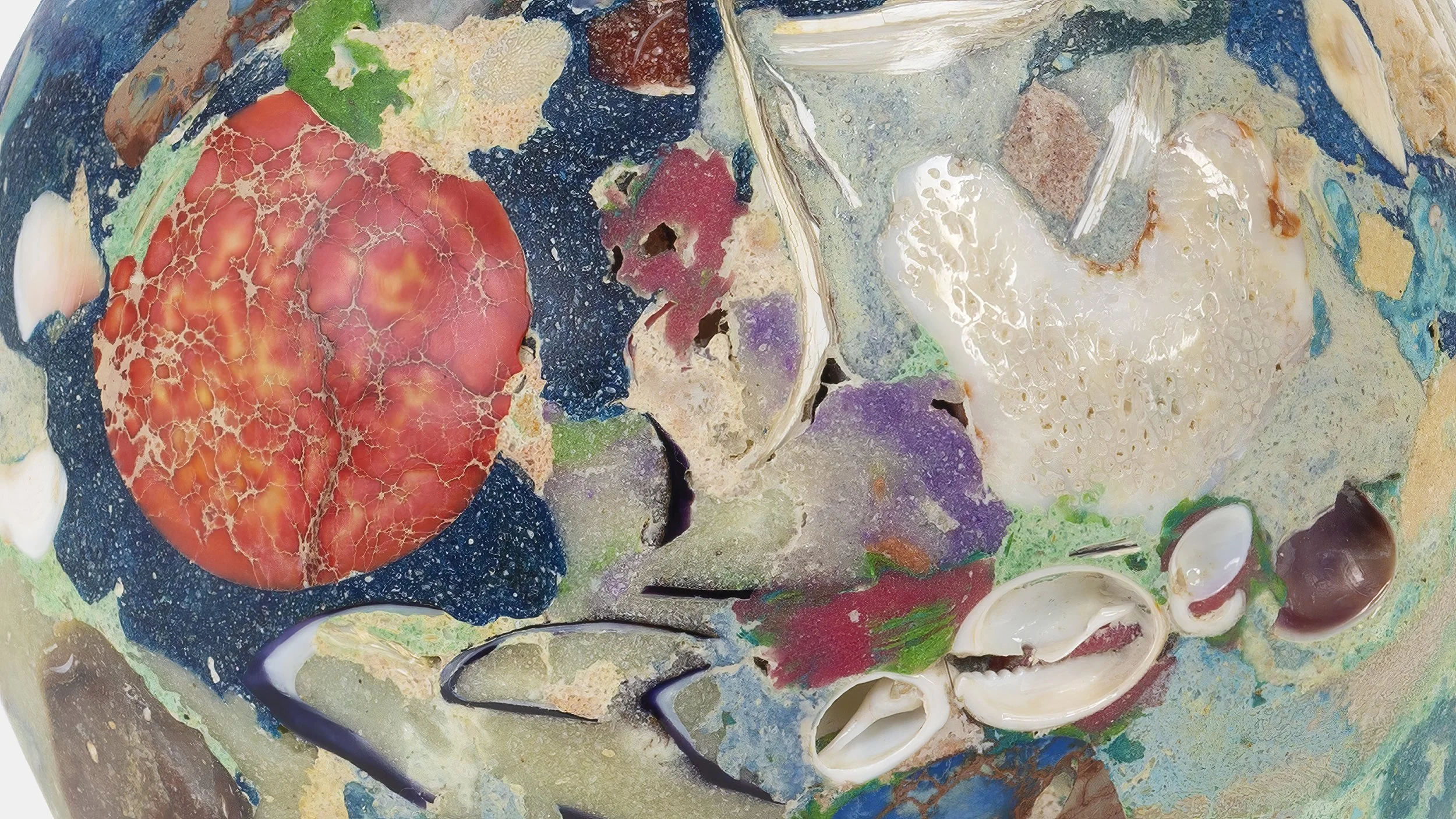 Yasue Maetake Orb Materia—Carved Algos detail: close-up of a carved reflective sphere surface with a prominent red coral-like form, shells, and multicolored mineral textures