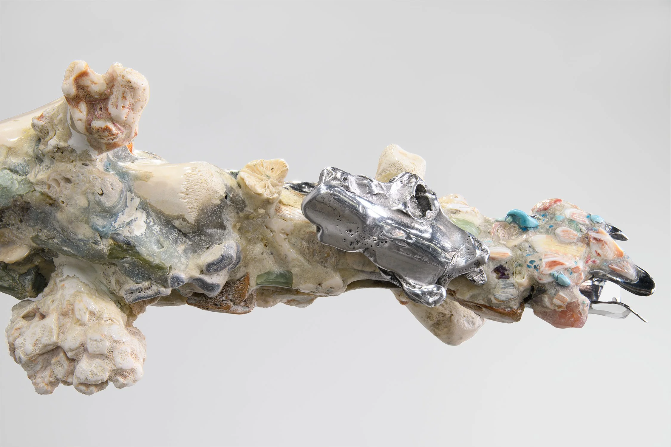 Yasue Maetake Mare Fecunditatis close-up: metallic bars fused with multicolored irregular accretions and textured surfaces against white background