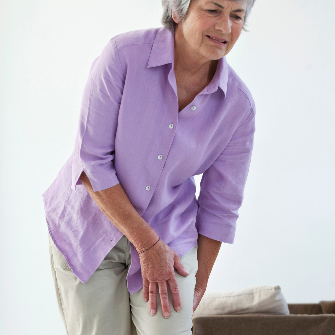 woman with sciatica pain clutching thigh