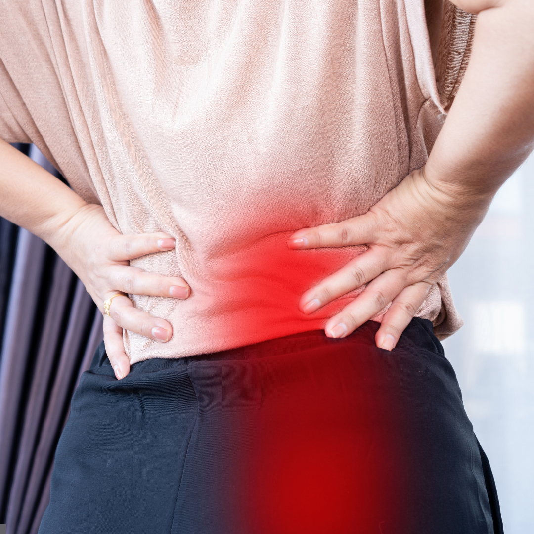 woman with hands on lower back with sciatica affected area highlighted in red