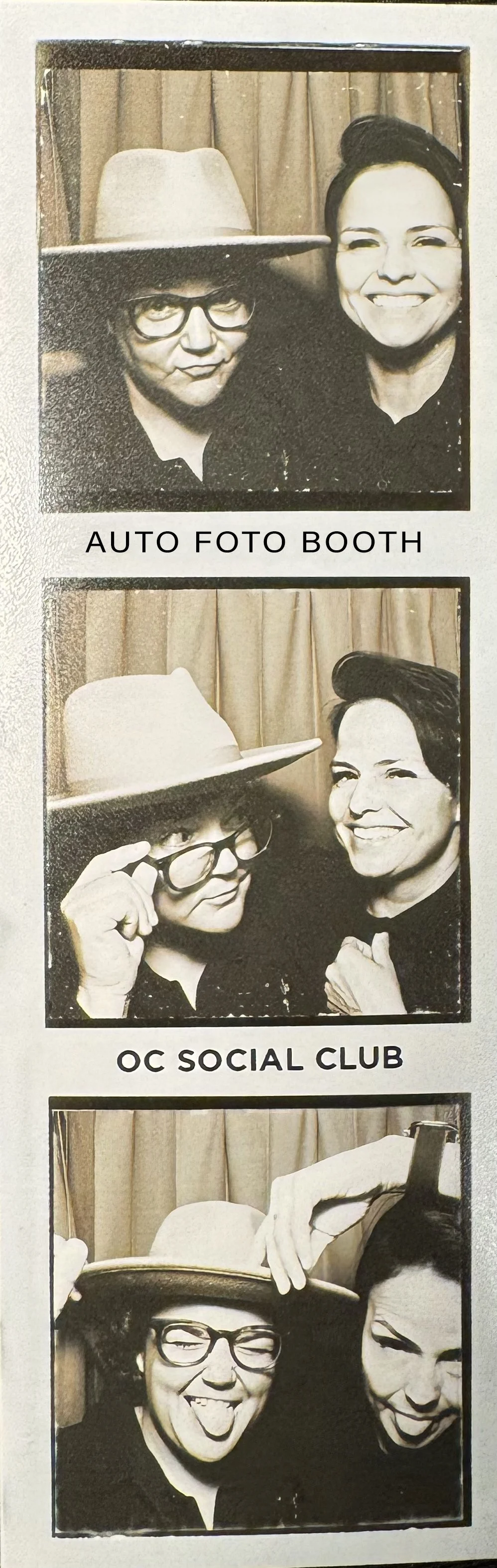 Three black-and-white photo booth strips featuring two women making funny faces and smiling, with a backdrop of curtains and one woman wearing a large hat and glasses.