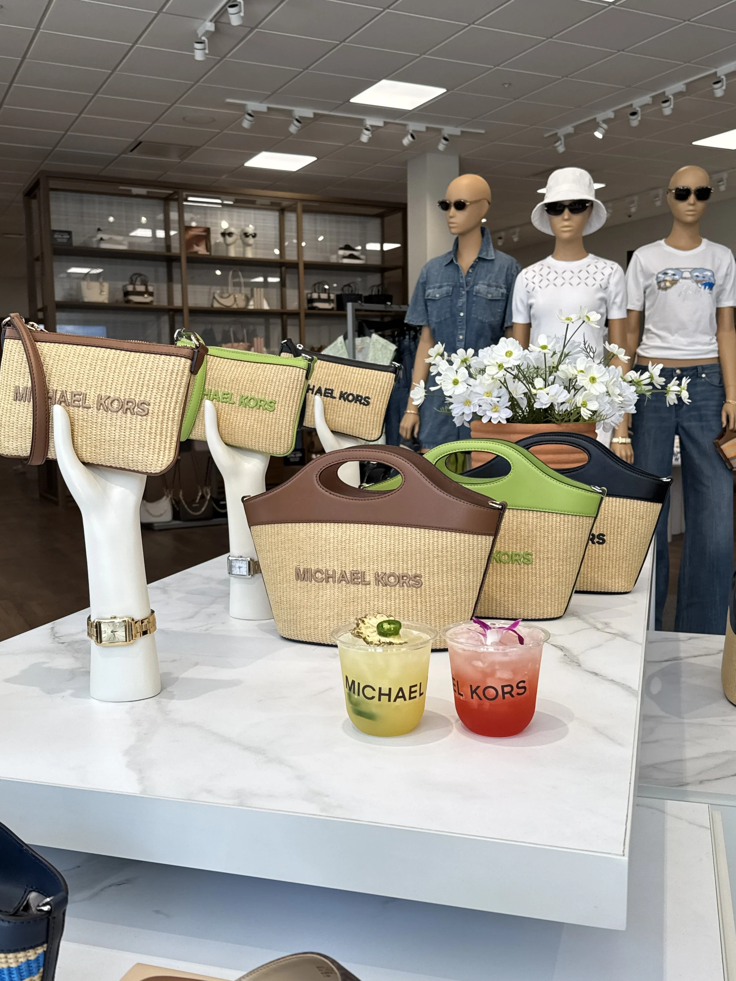 Custom mocktail station served at a Michael Kors retail event. Fresh-pressed juice mocktail menu crafted by BUBBLES Mobile Bar.