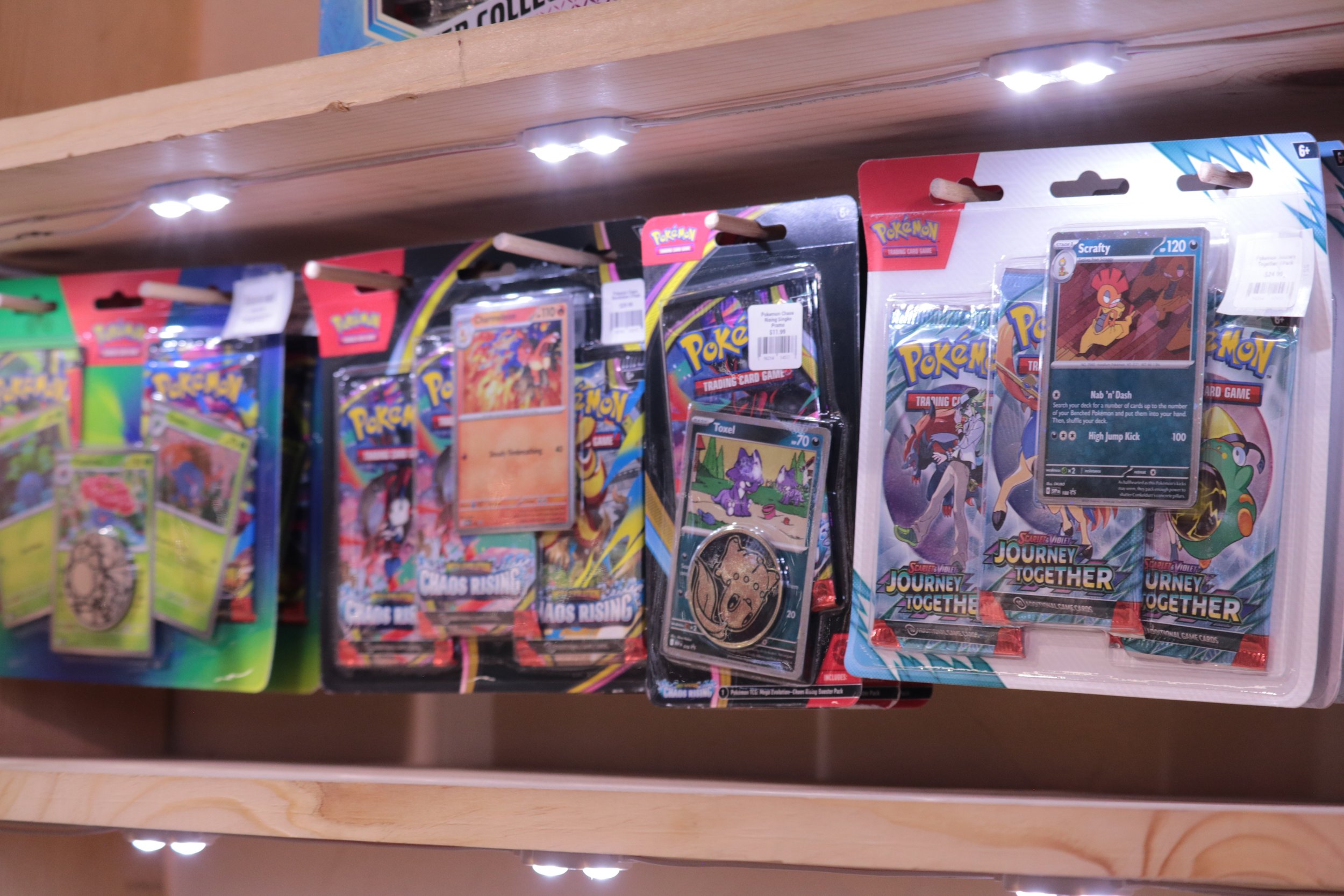 Assorted Pokémon trading card packs displayed on a store shelf