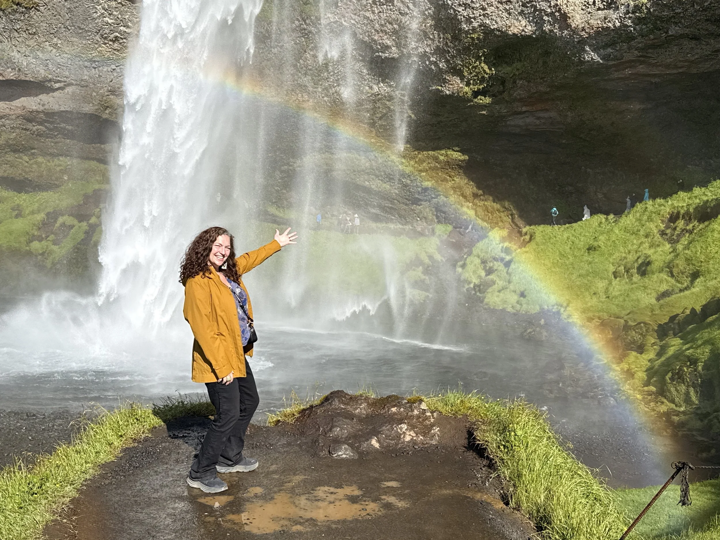 Angie in front of an Rainbow at Sejalandsfoss. Iceland