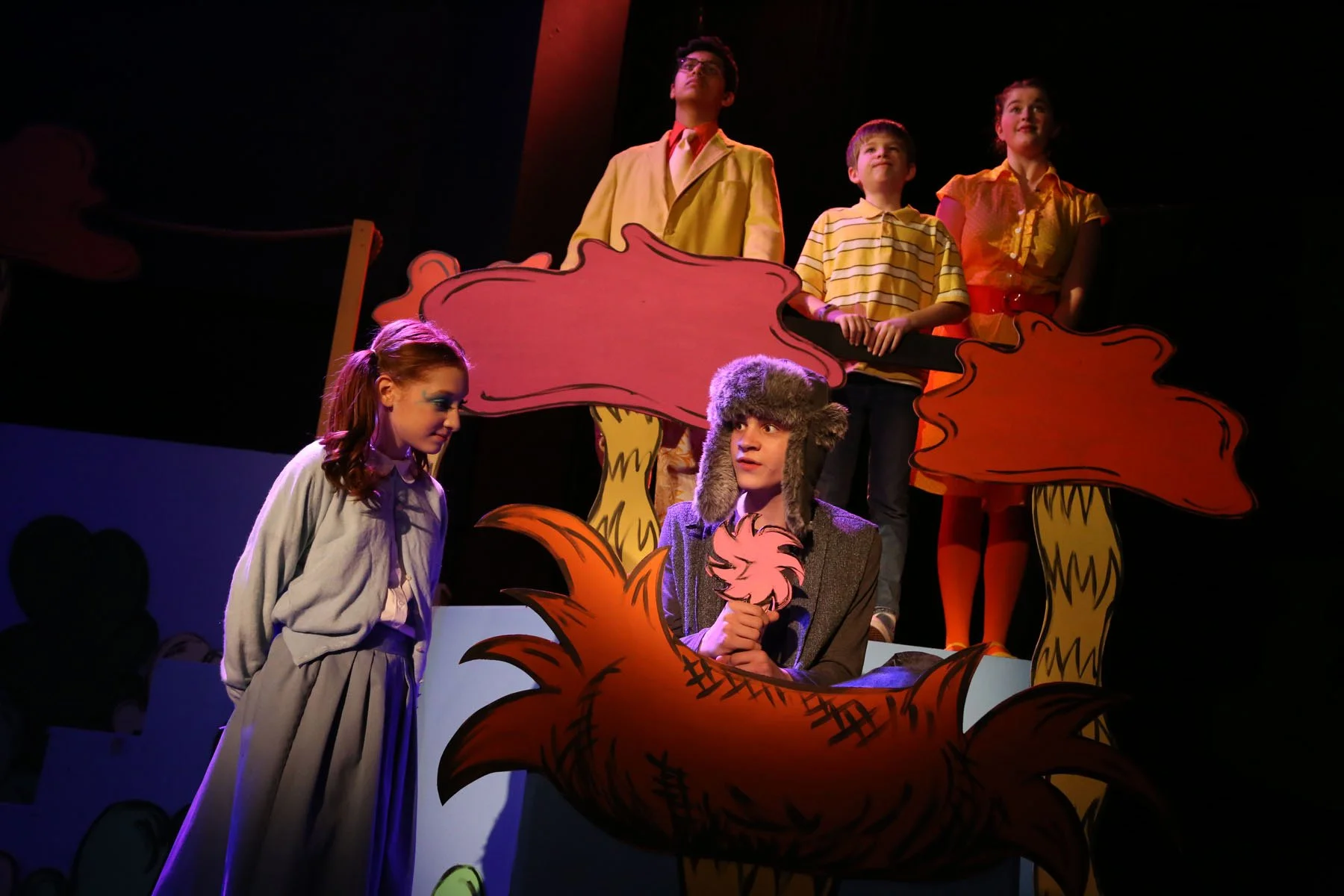 Children performing on stage inSeussical Jr., with colorful props and costumes.