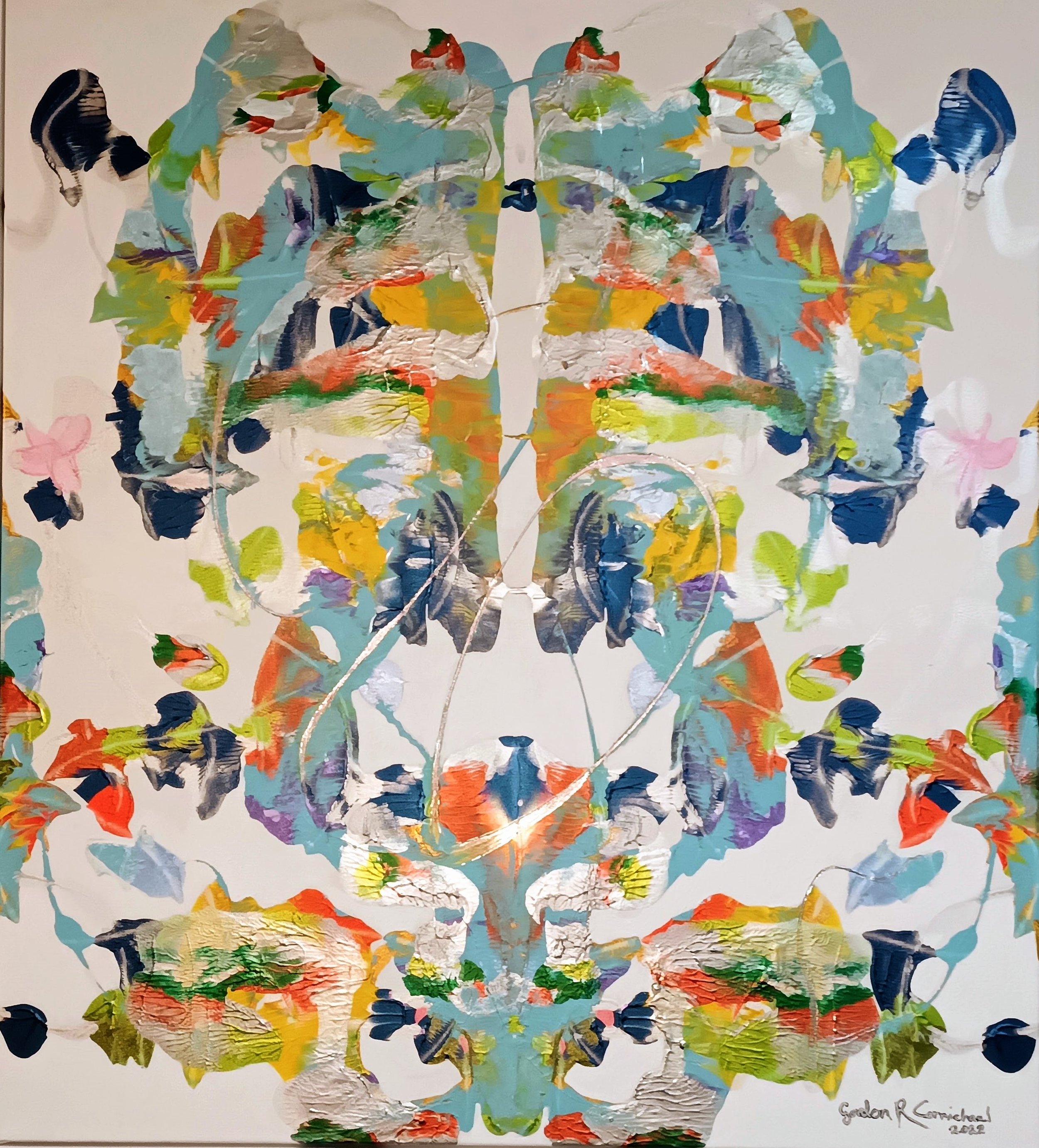 Lumins 2024.
Abstract colourful painting with symmetrical patterns, featuring various shades of blue, green, orange, yellow, purple, and white, resembling butterfly wings or floral shapes.